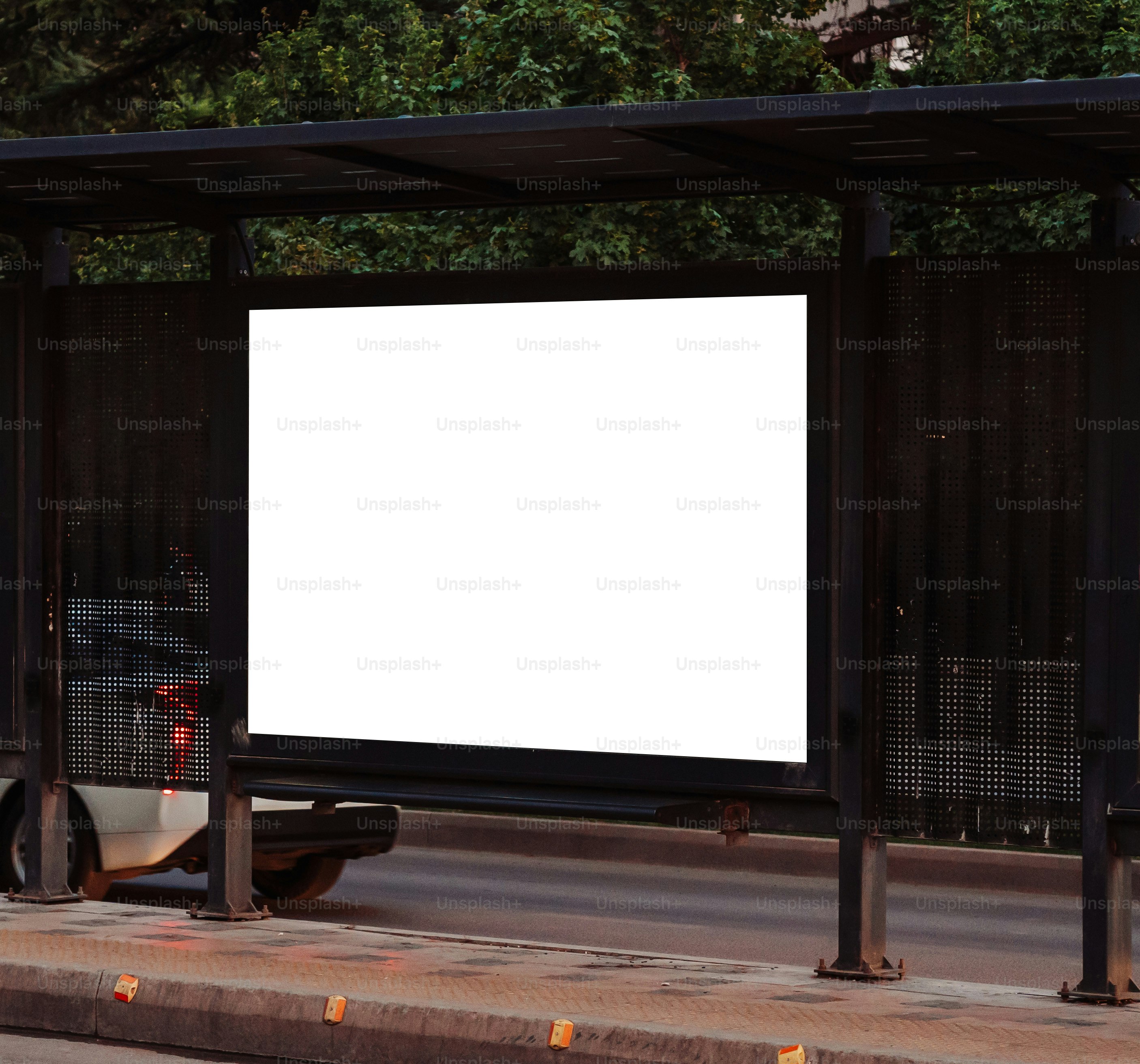 A blank billboard at a bus stop.