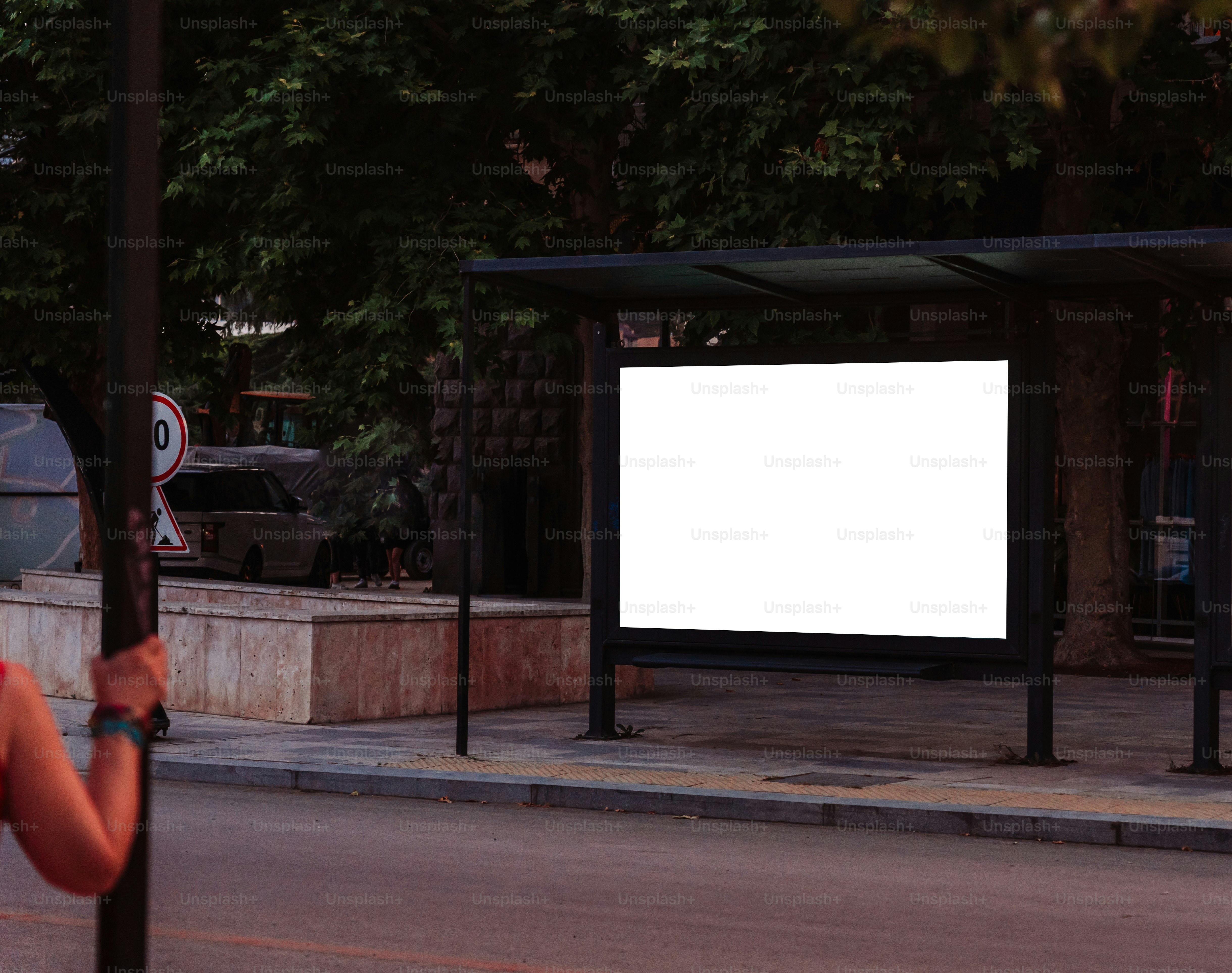 An empty billboard awaits advertisement on a bus stop.