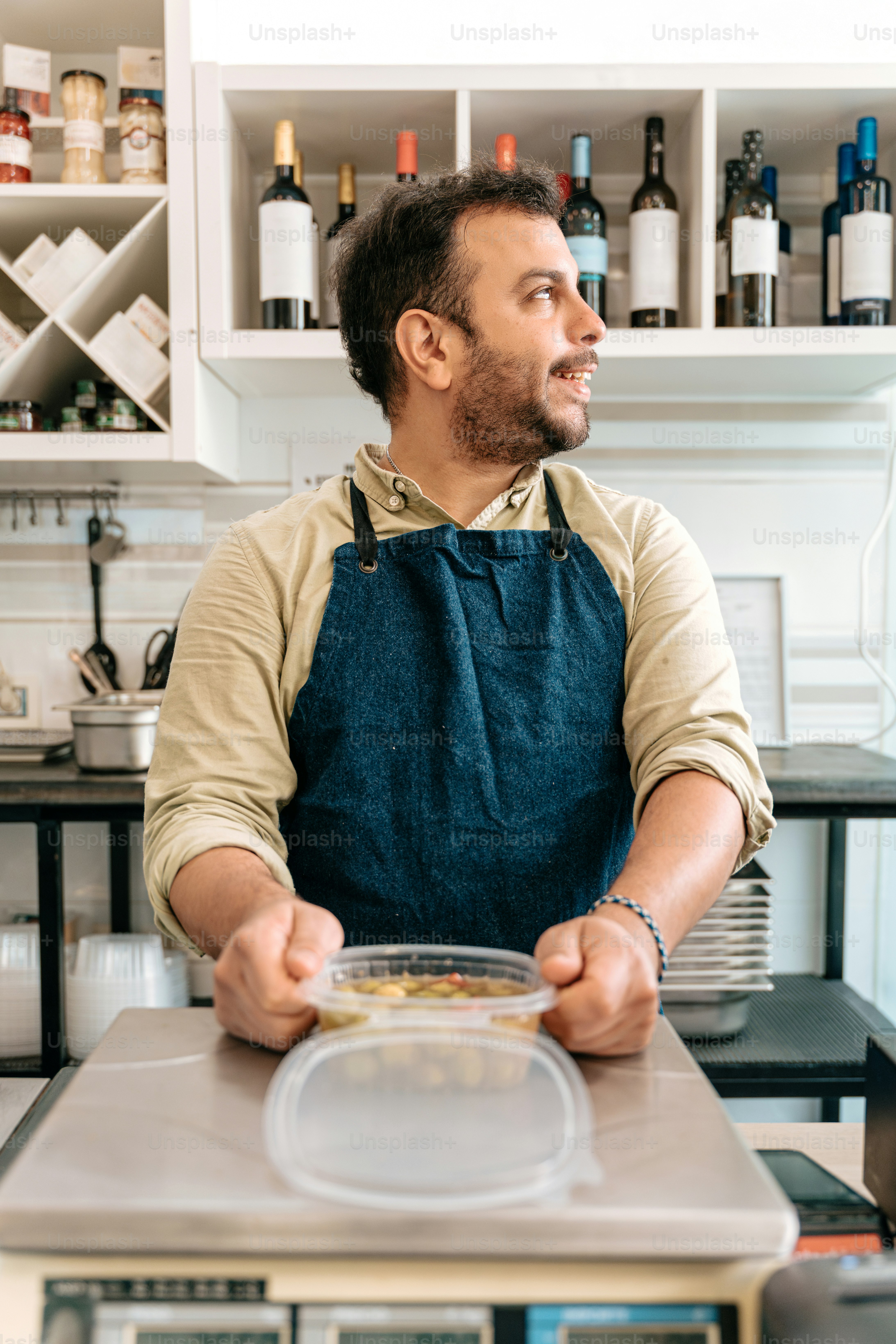 A shopkeeper weighs food at the counter. photo – Food industry Image on ...