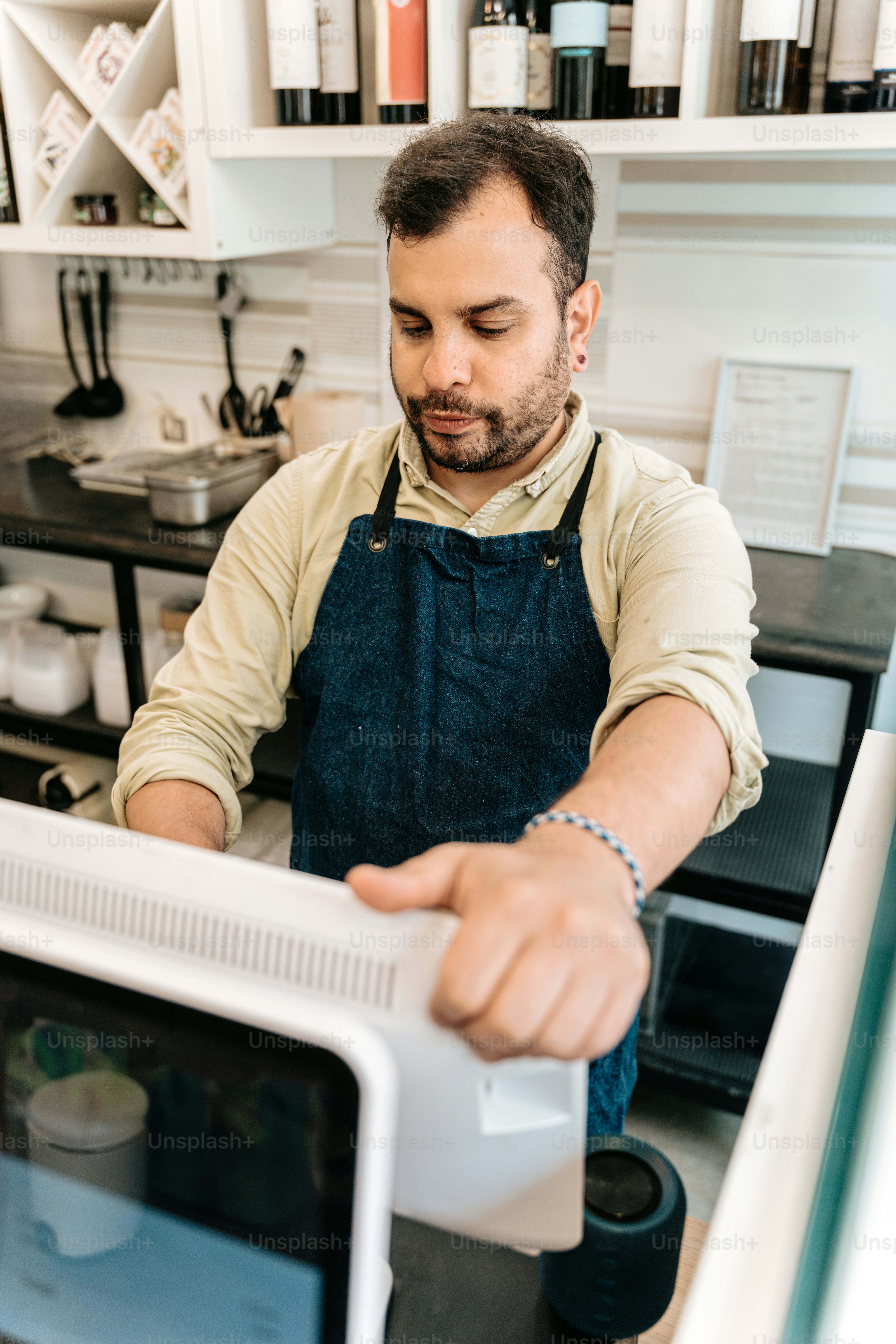 Store owner at counter