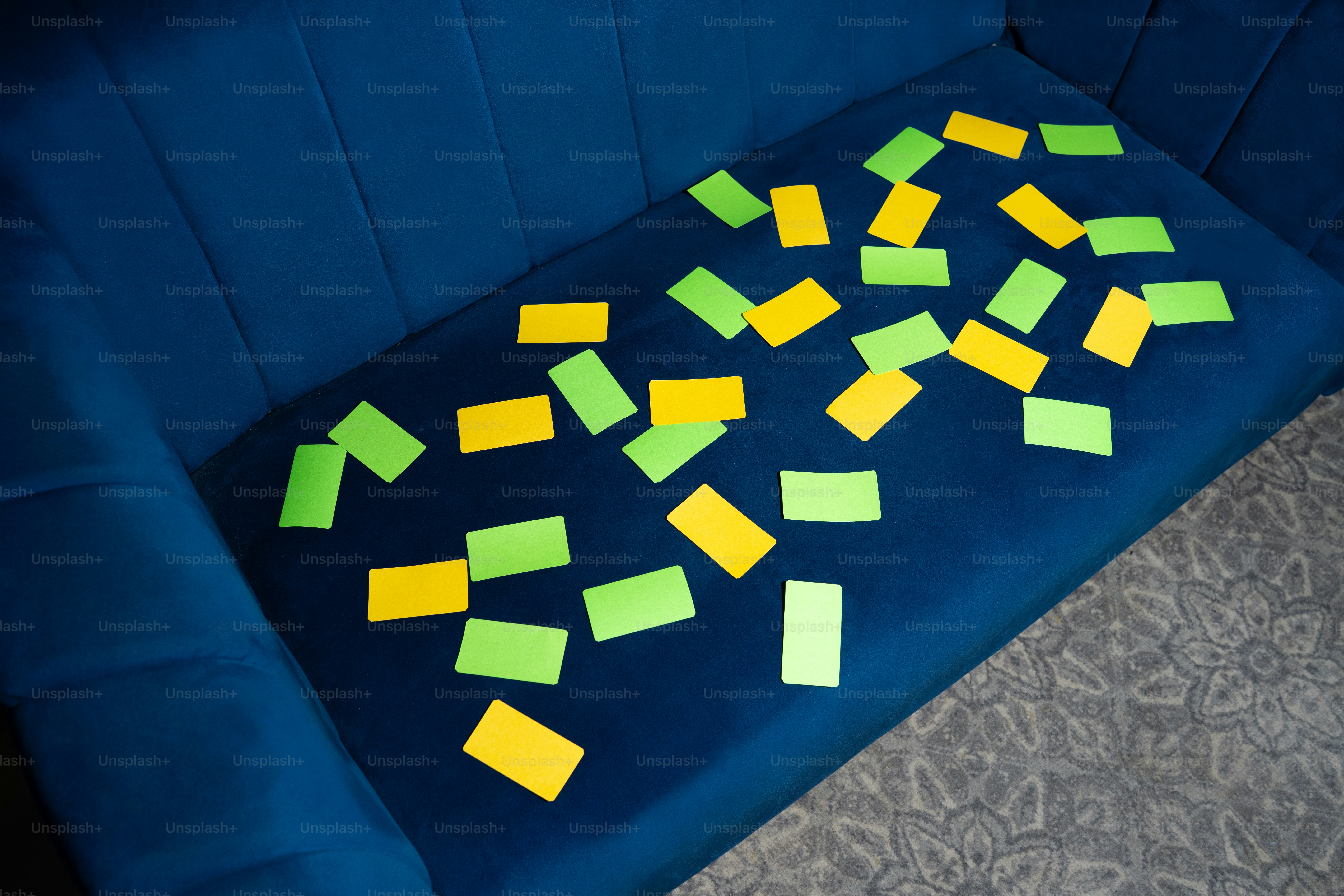 Yellow and green sticky notes litter blue couch. photo – Mockup Image ...