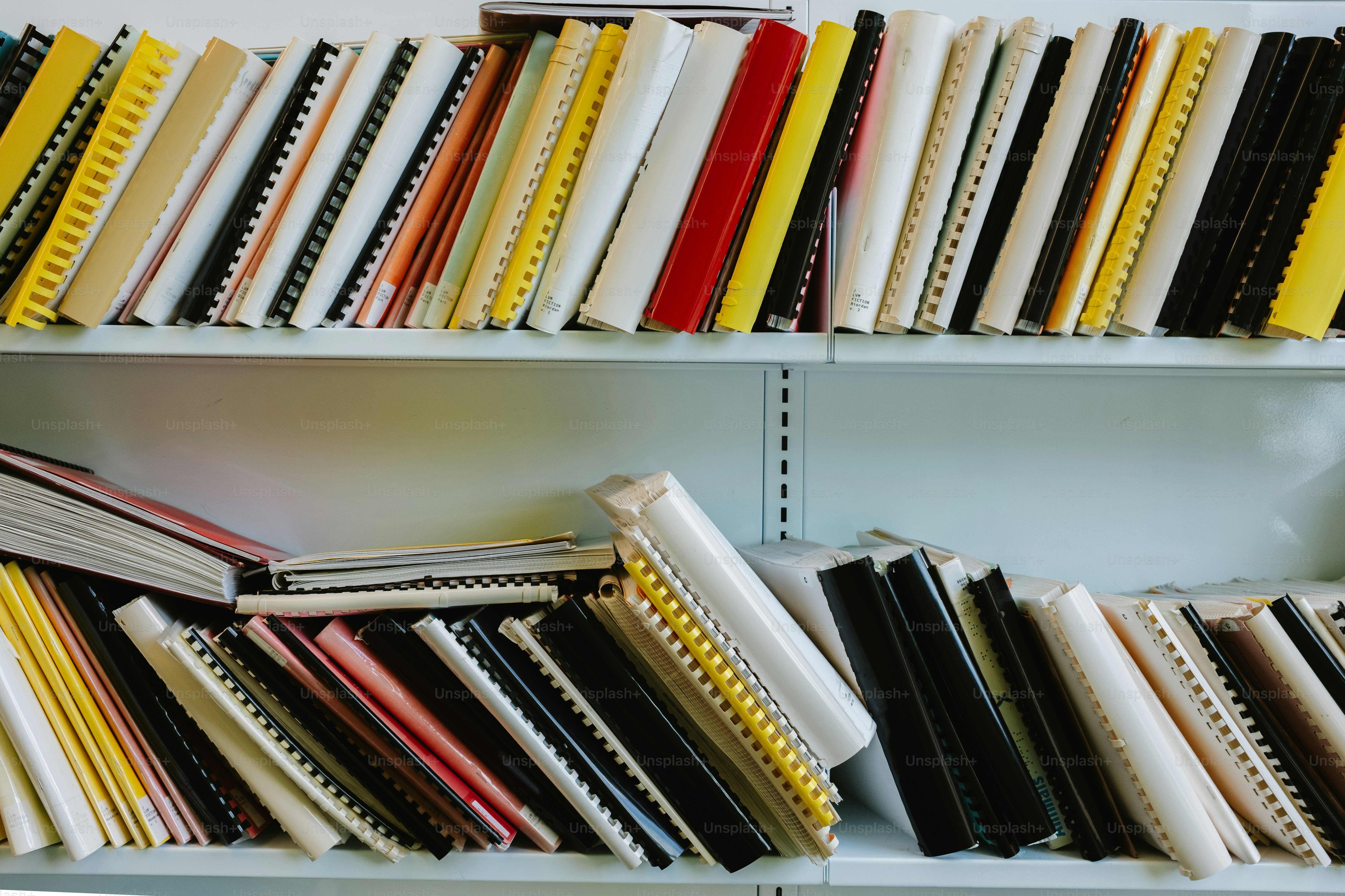 Shelves are full of colorful, bound books.