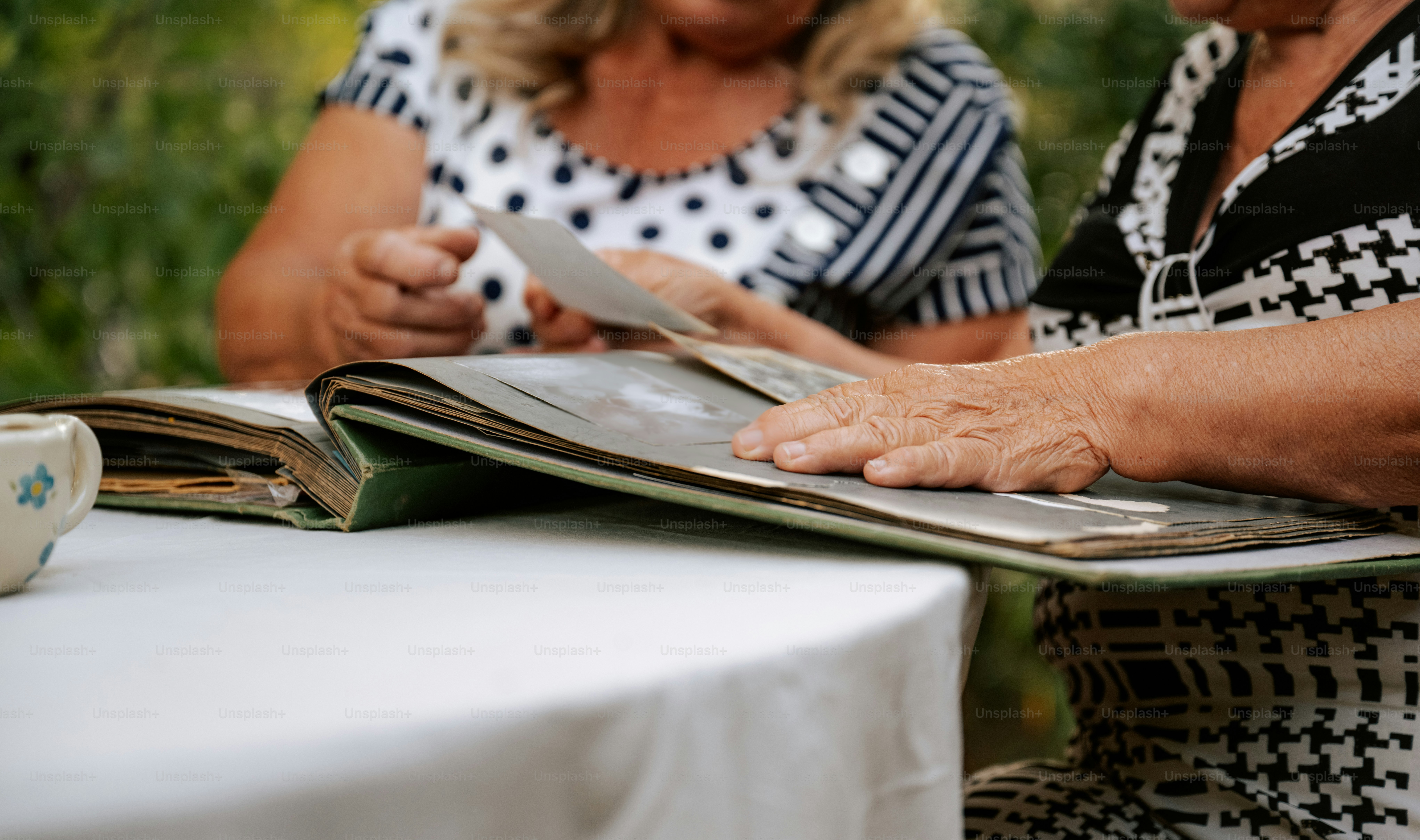 Two women look through an old photo album.