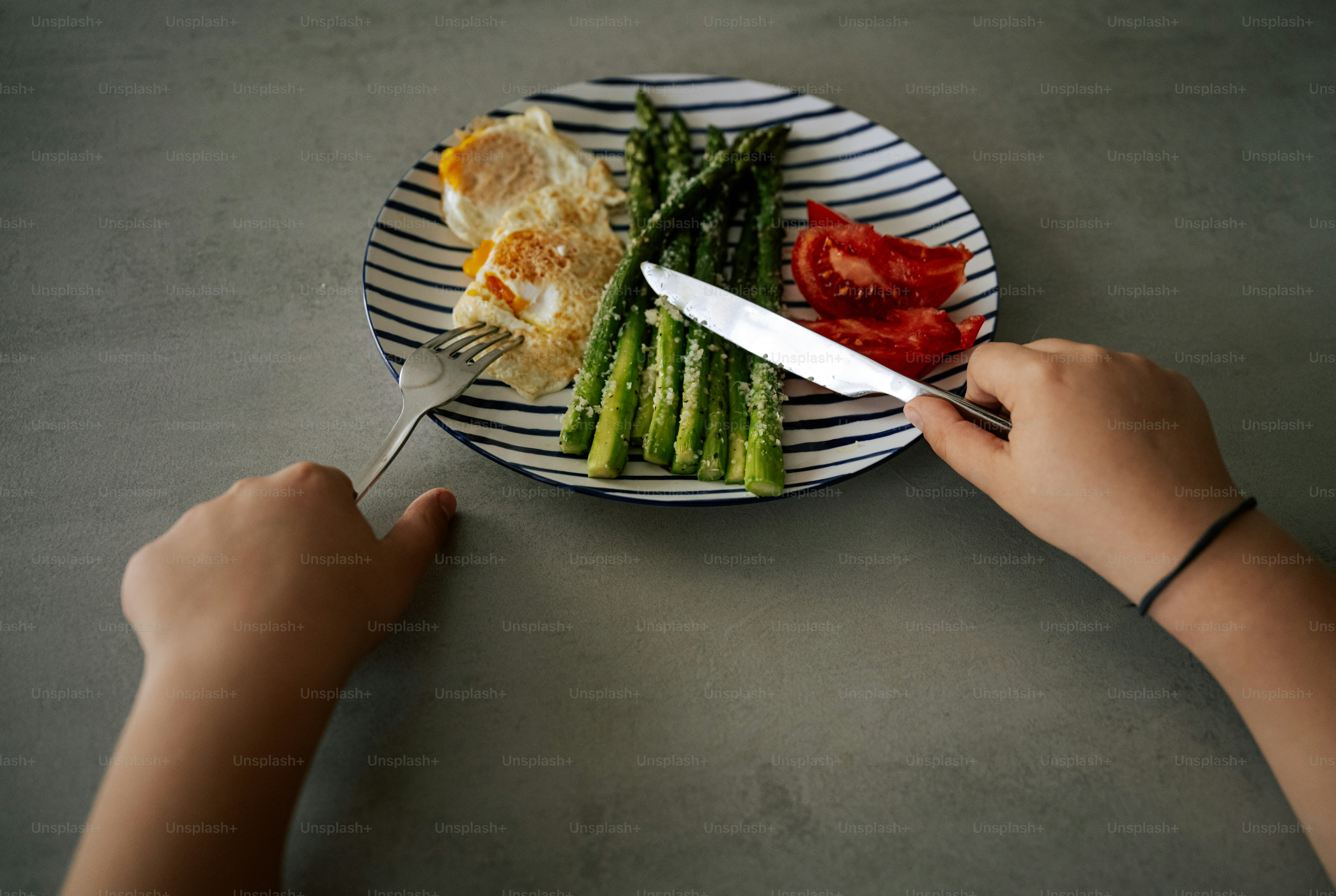 Person is about to eat breakfast with fresh vegetables.