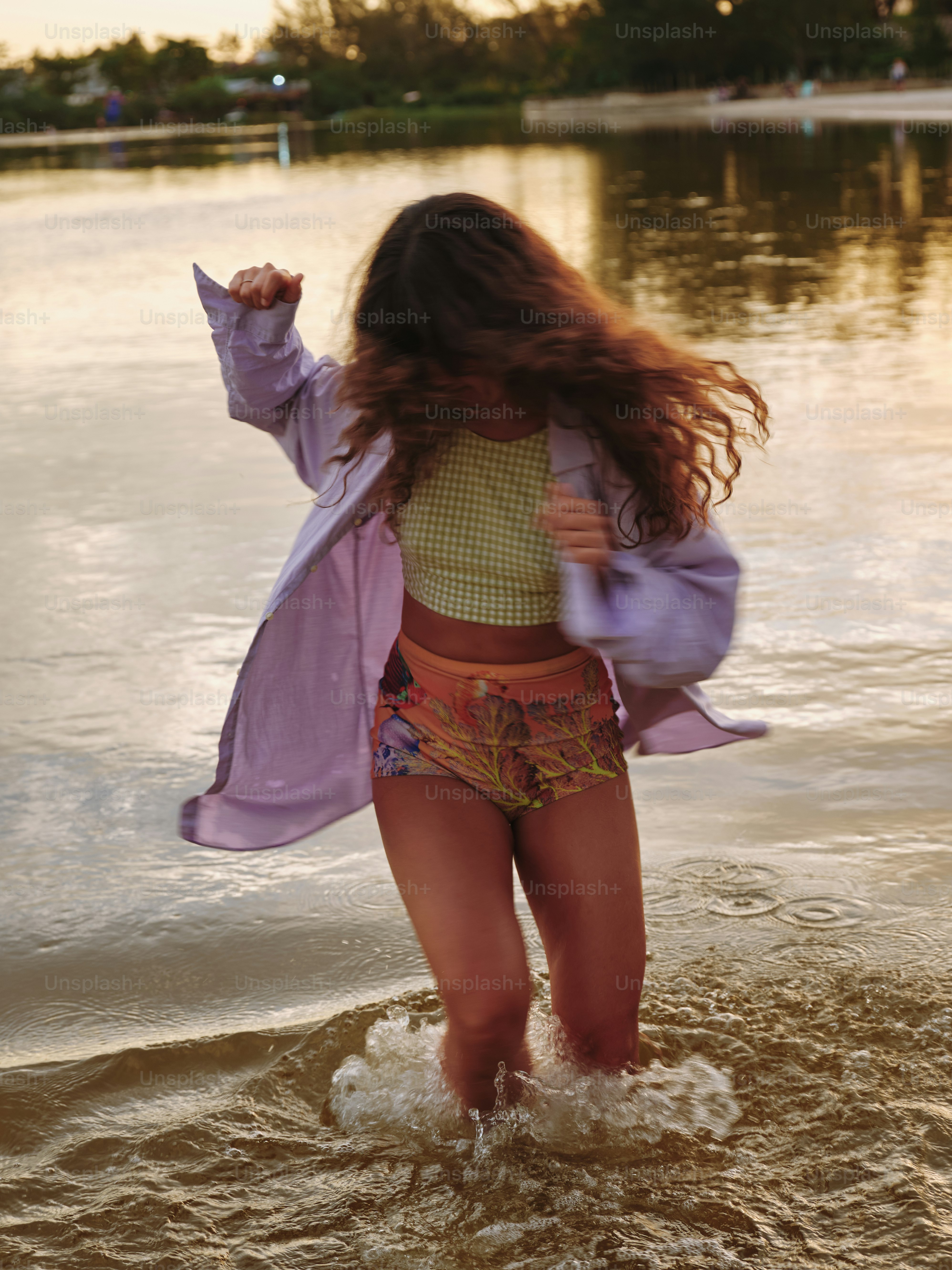 A woman splashes in the water playfully