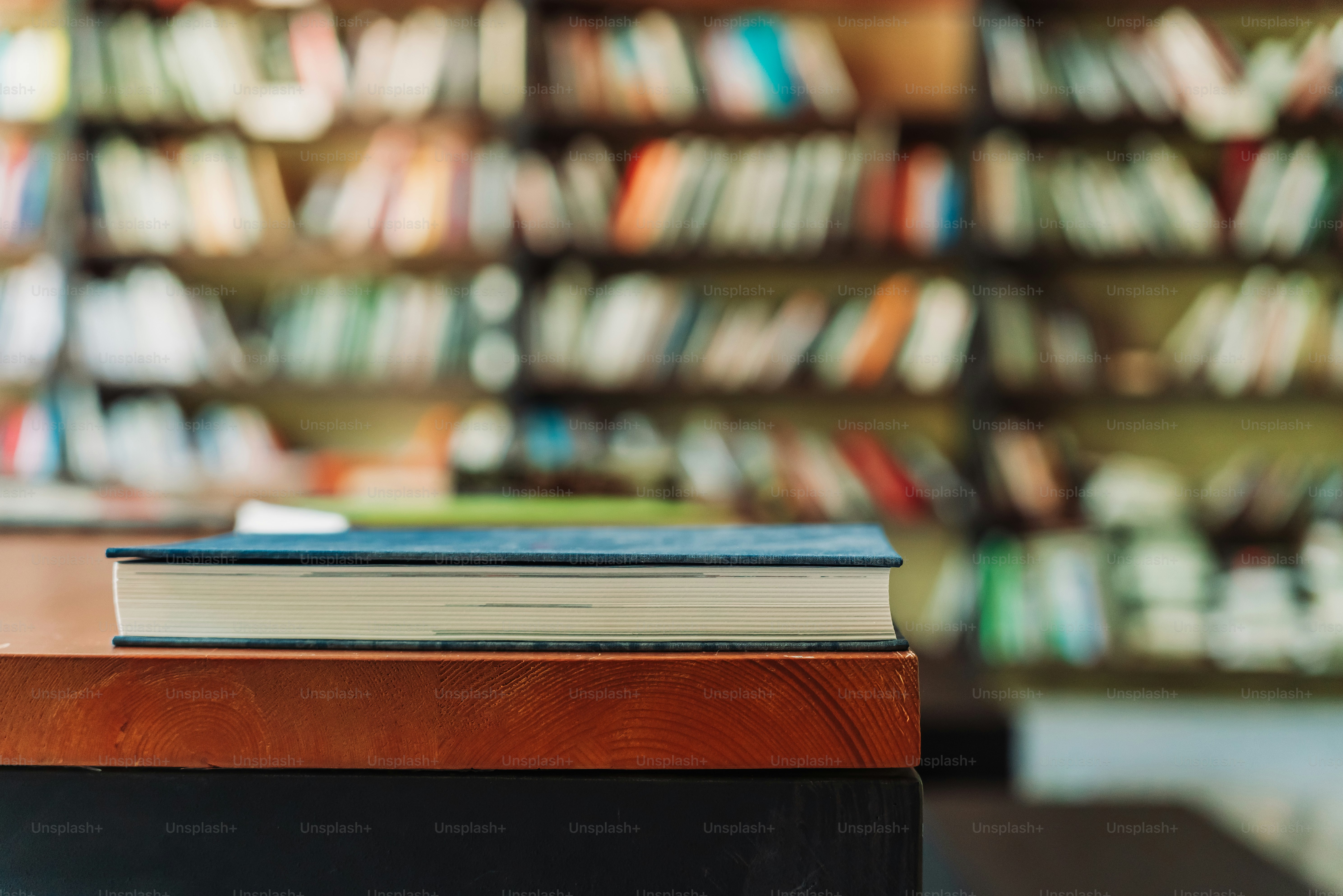 A book rests on a wooden table. photo – Books Image on Unsplash
