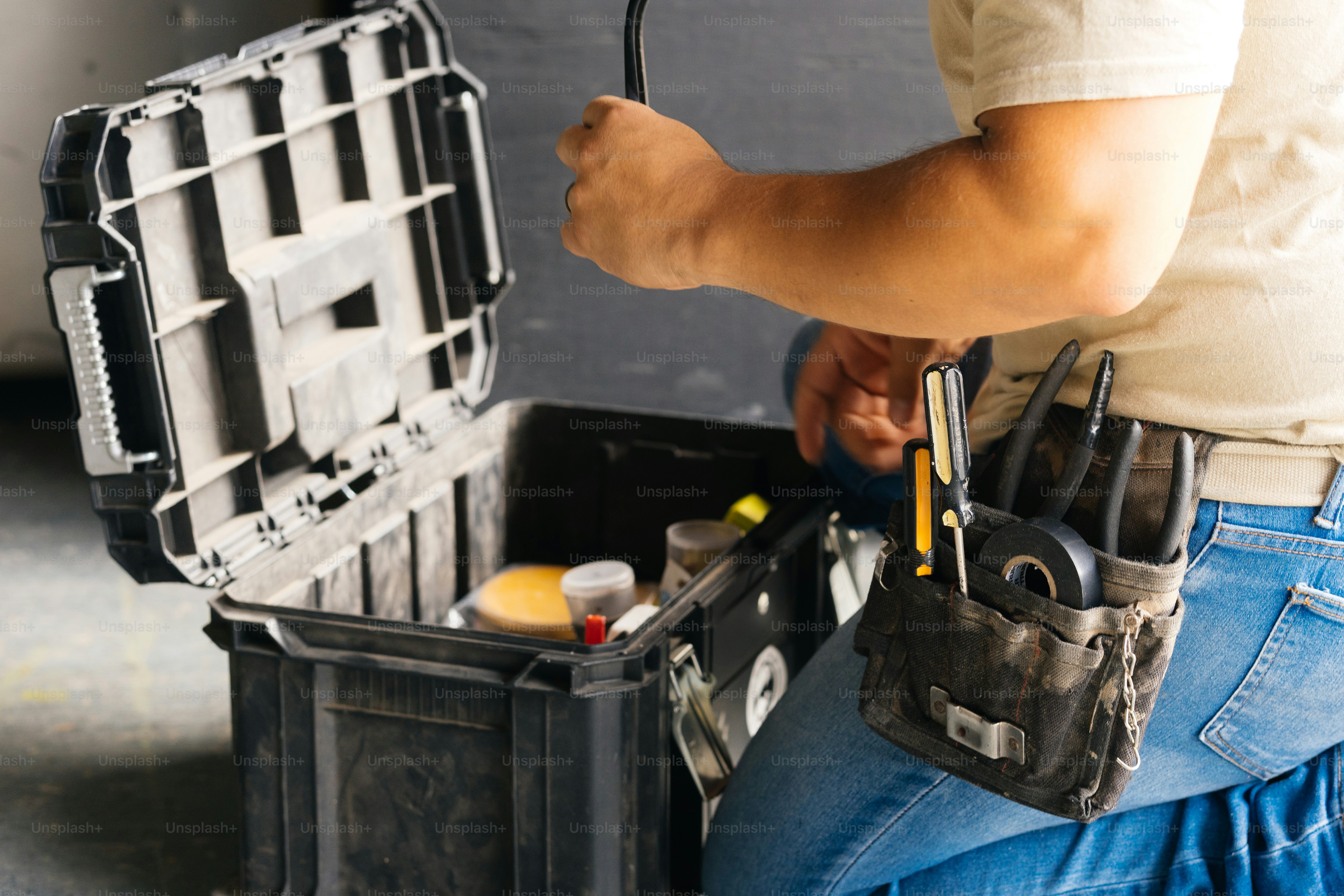A worker opens a toolbox for repair.
