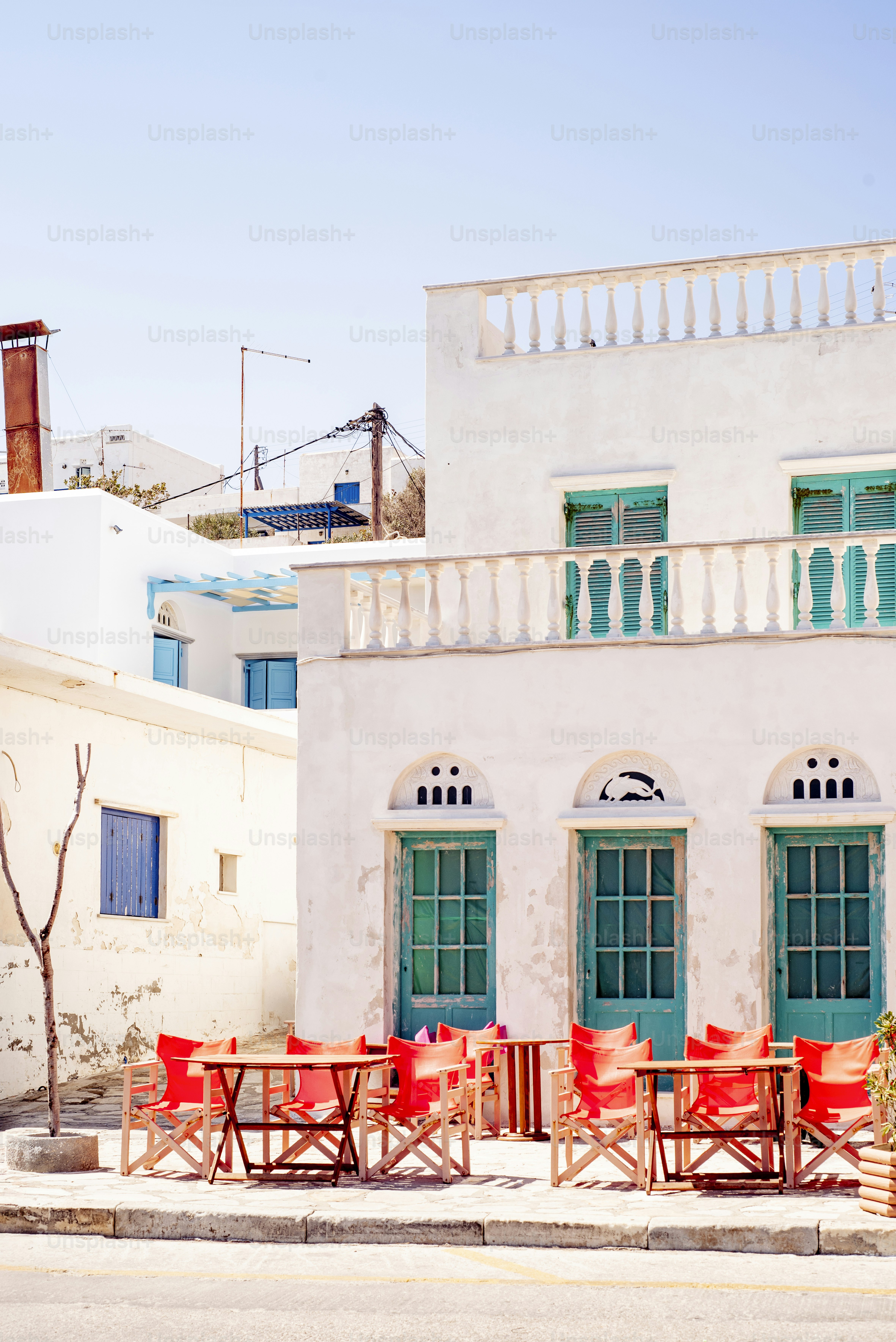 A charming outdoor cafe with white buildings.