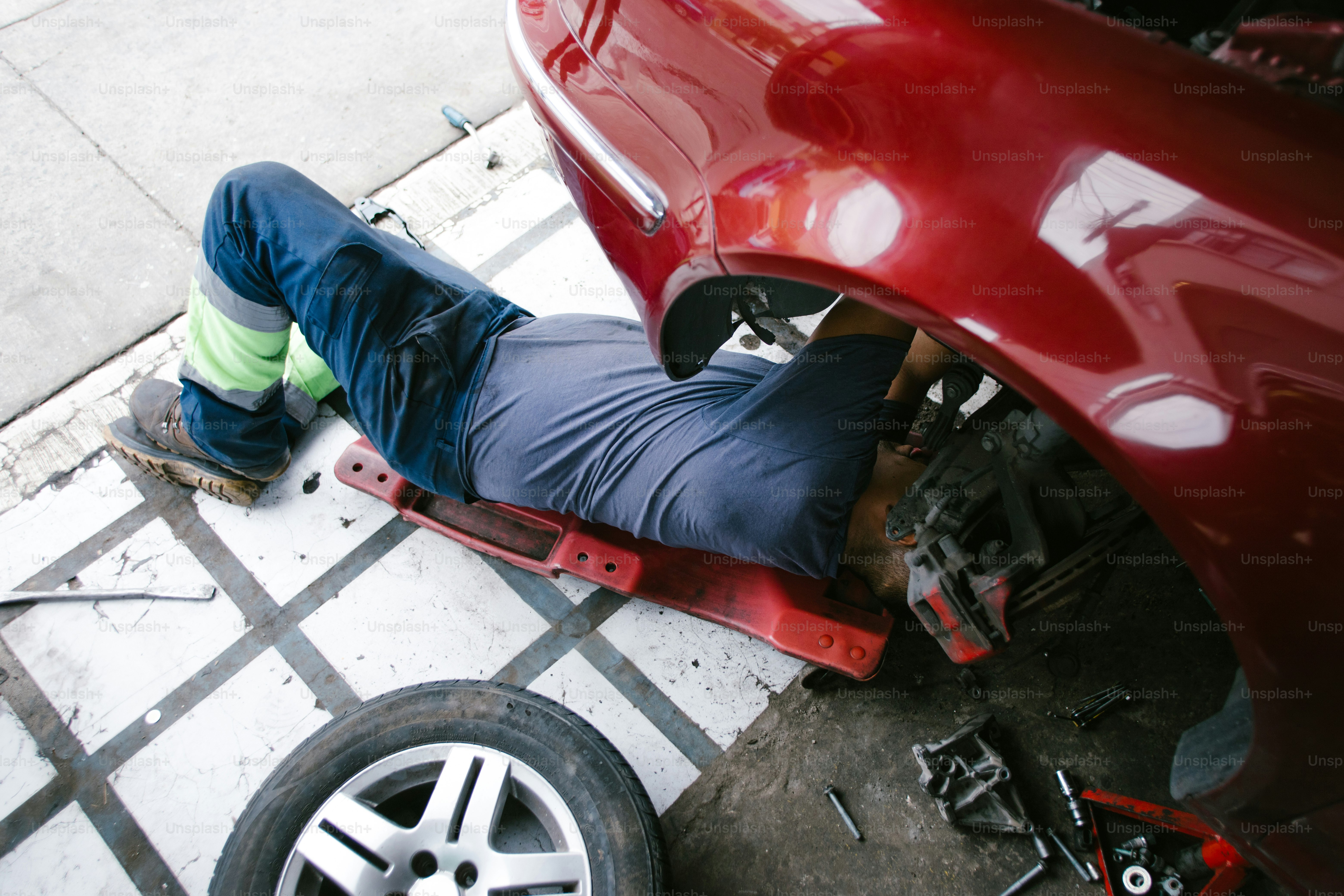 Driver checking cold tire pressure as part of winter vehicle care.