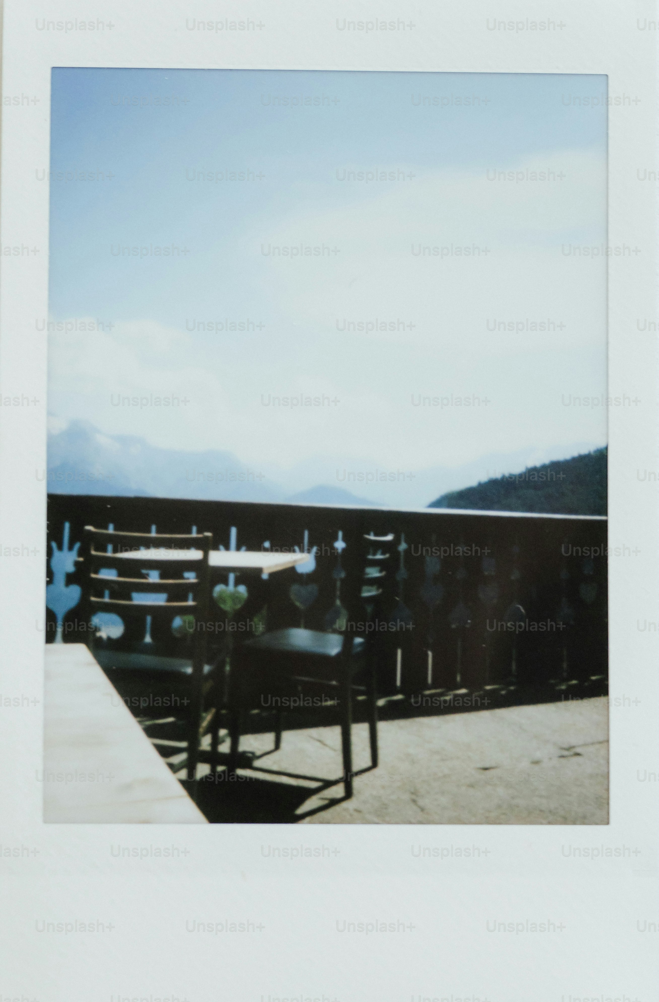 A table and chairs with a beautiful mountain view.