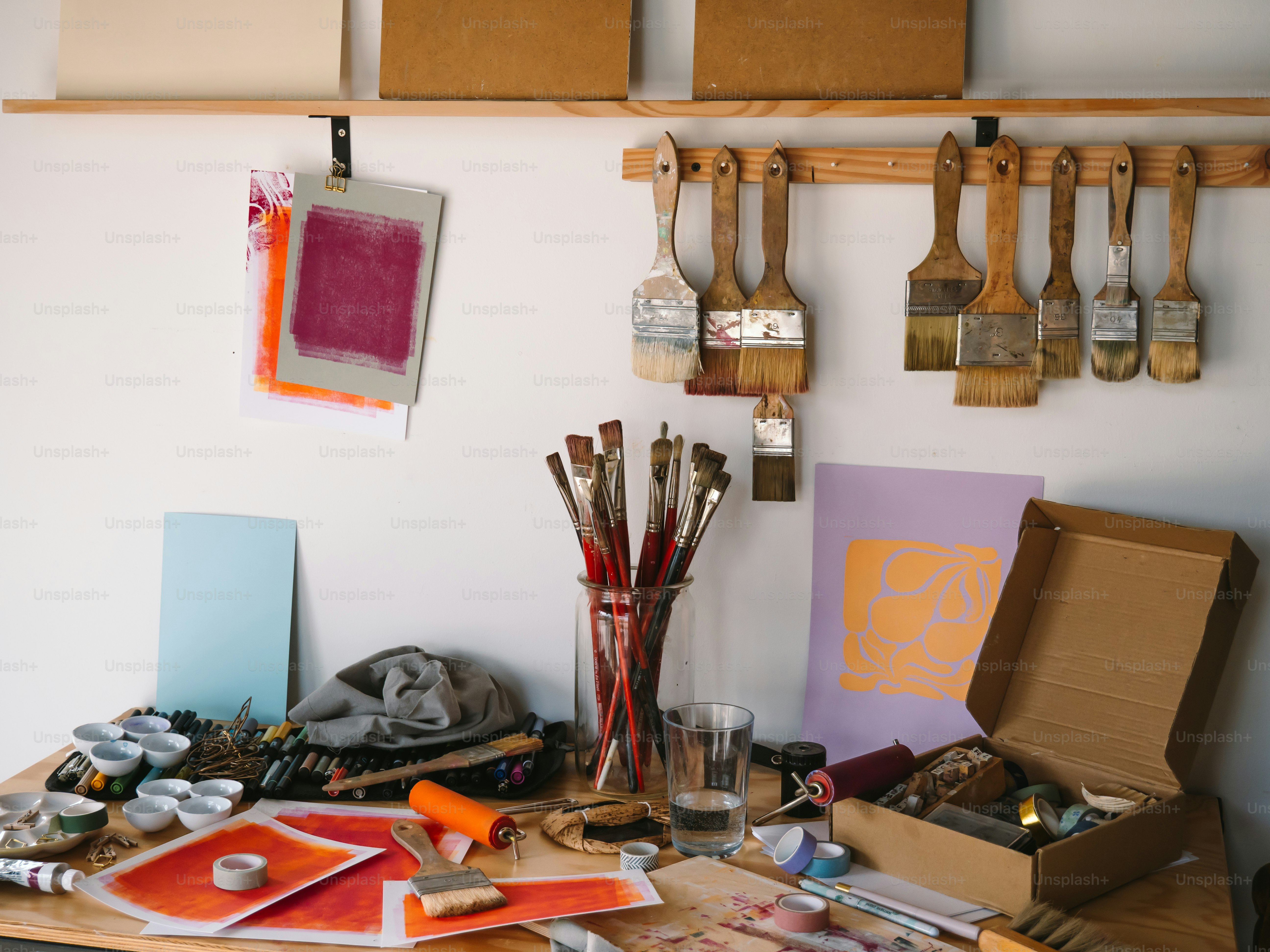 An artist's messy workspace is full of tools. photo – Art Image on Unsplash