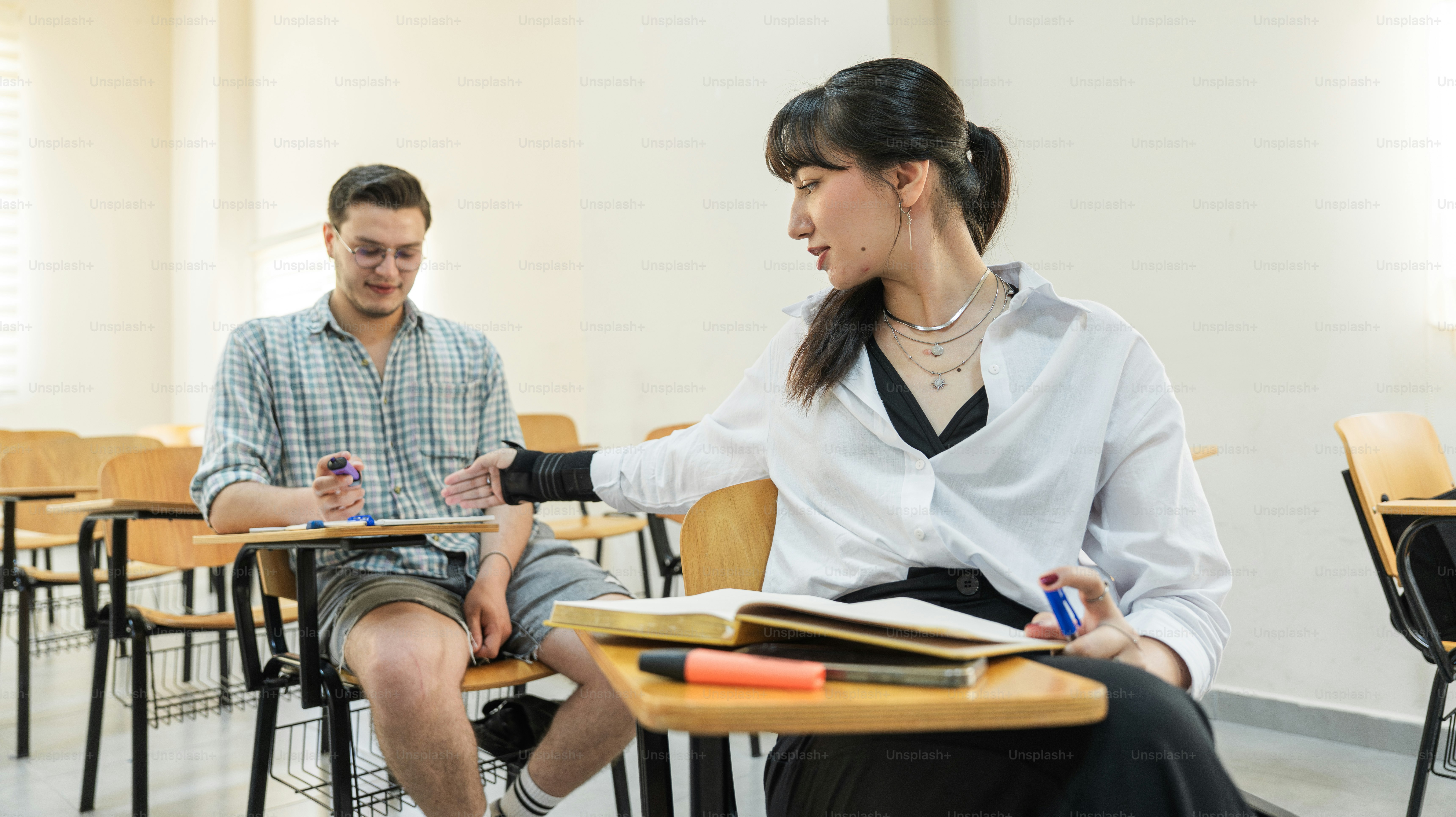 A student is talking to another in the classroom. photo – Education ...