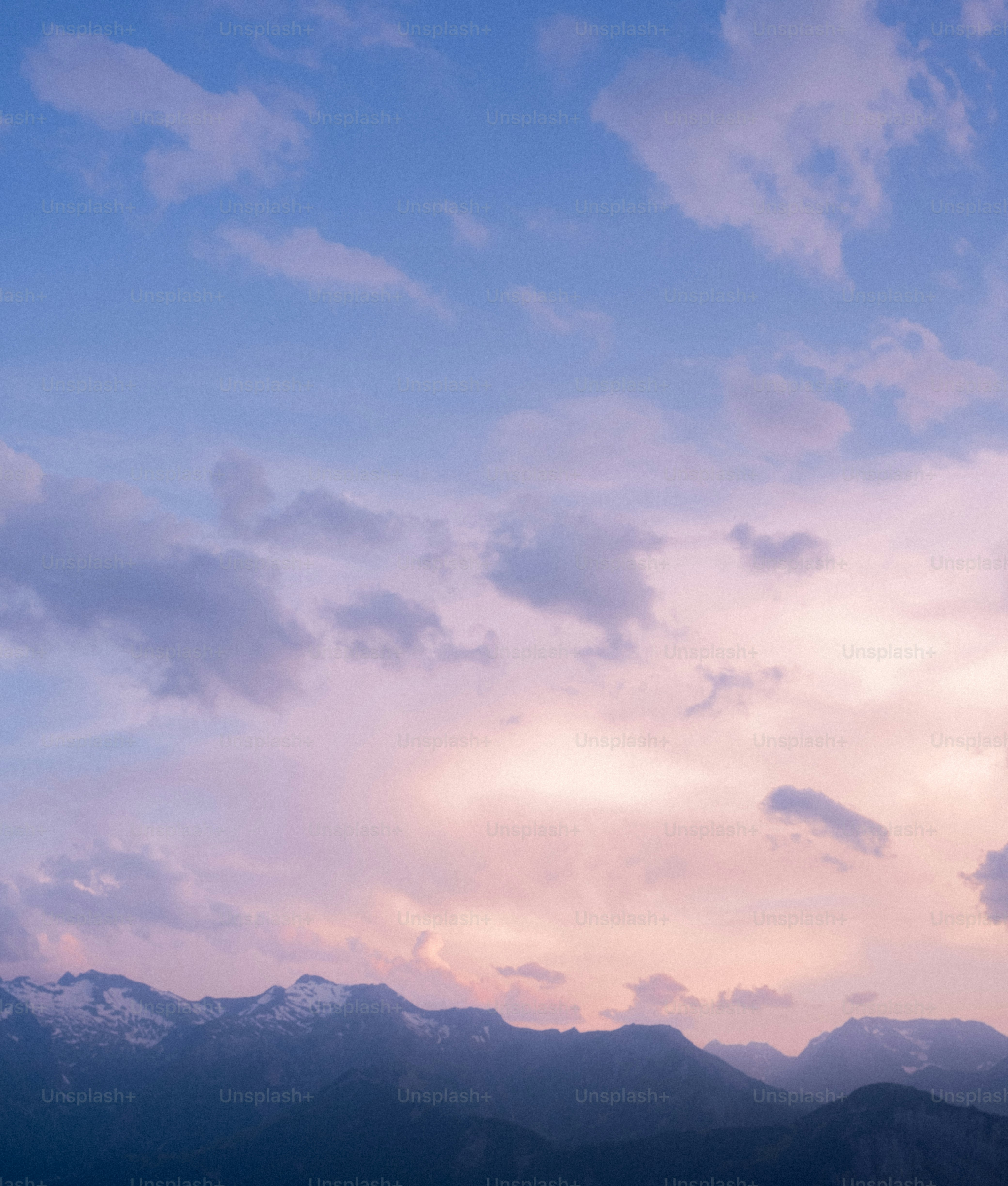 Mountains silhouetted against a pastel sky.