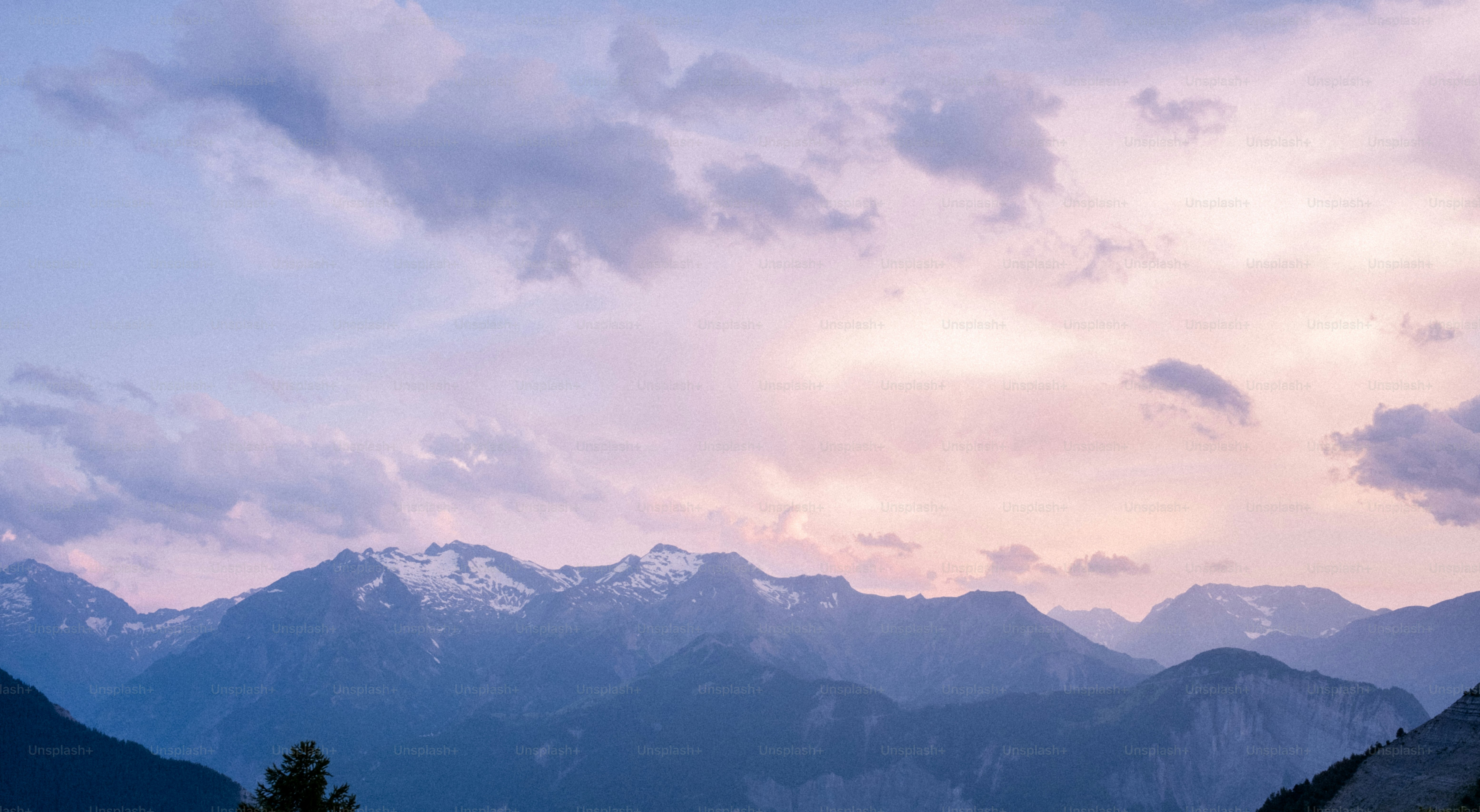 Mountains peak under a gorgeous, cloudy sky.