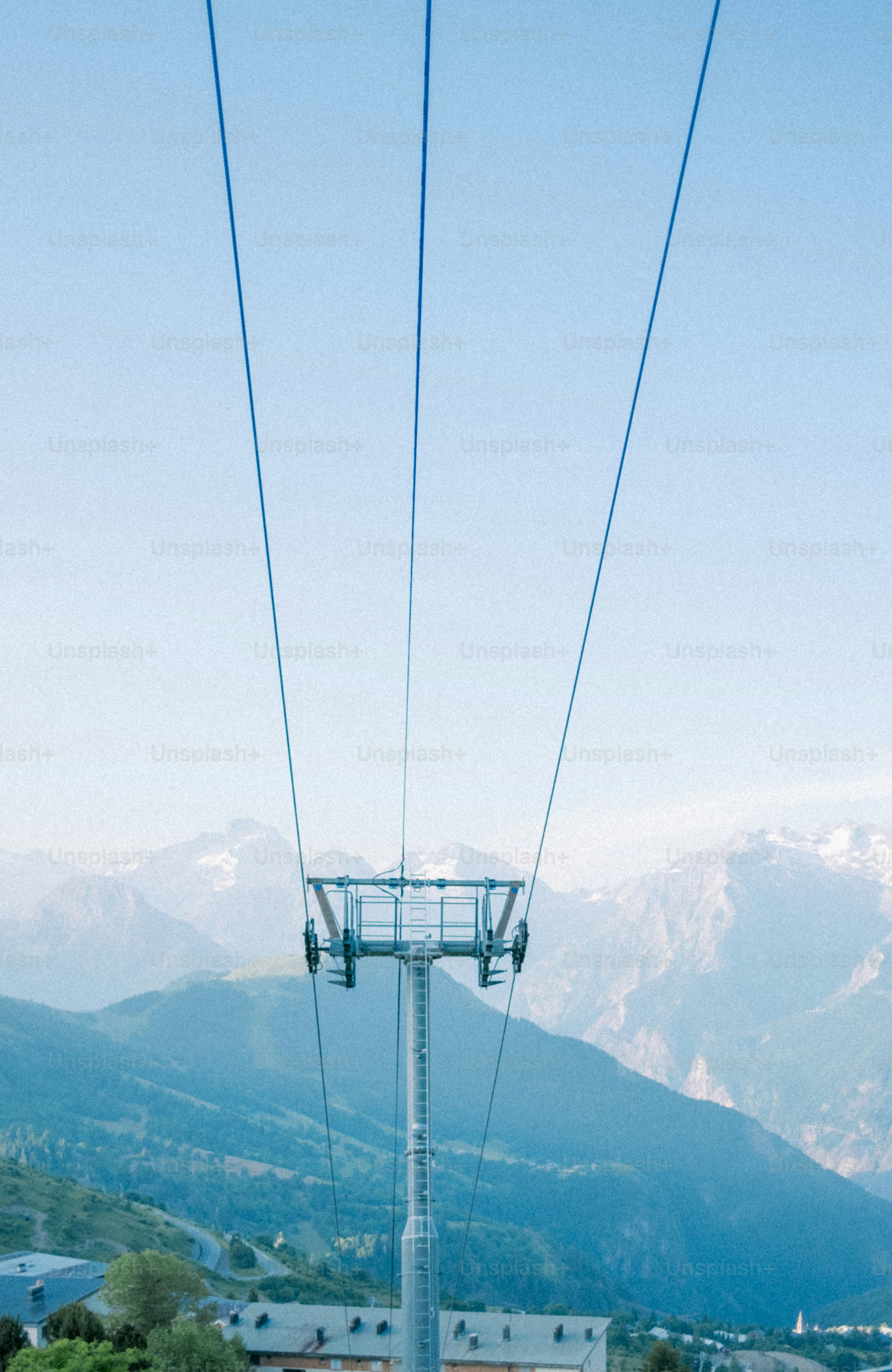 A ski lift with mountains in the background.