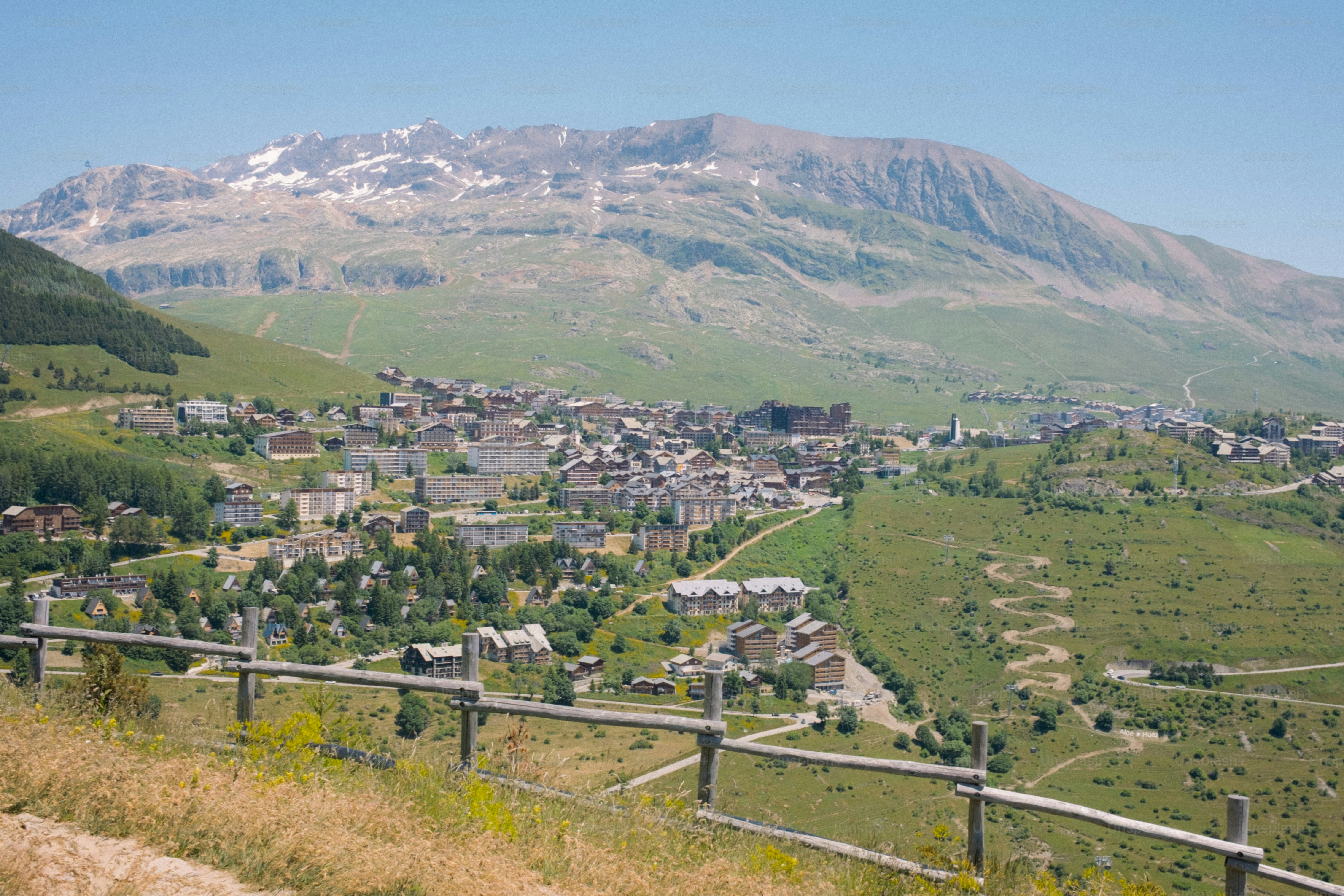A mountain town sits beneath a vast mountain.