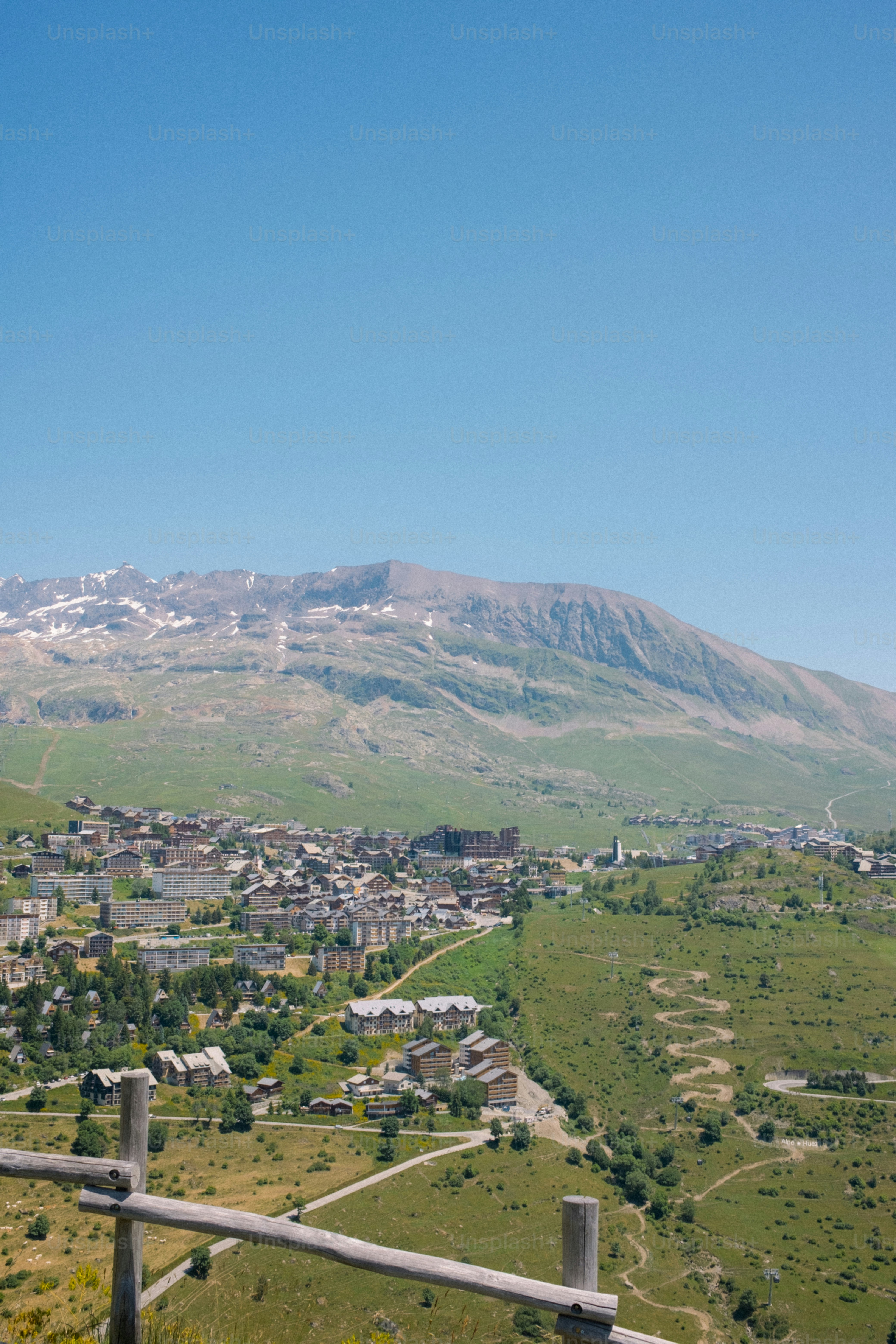 A mountain town sits nestled below a snow-capped peak.