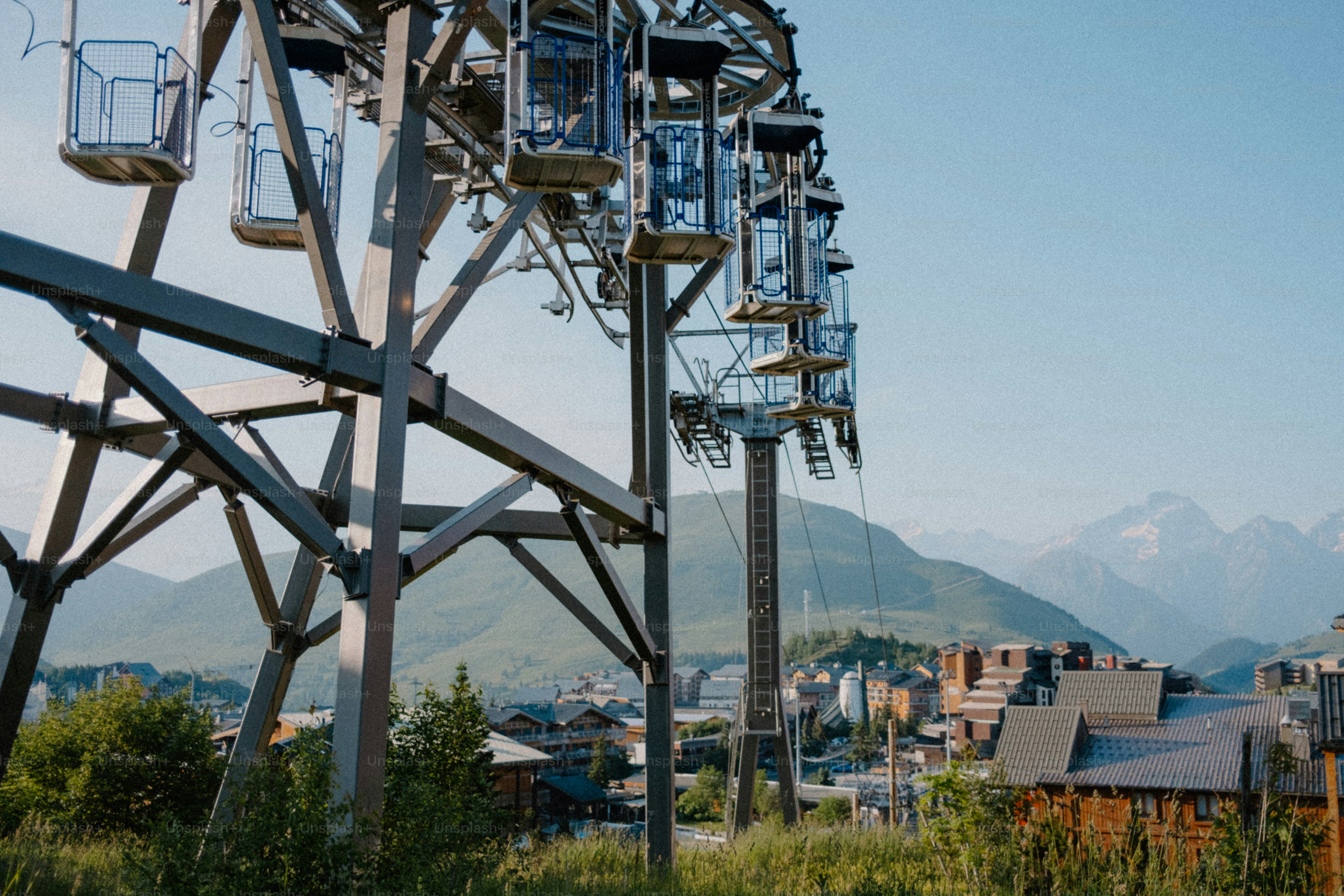 A ski lift is ready above mountains.