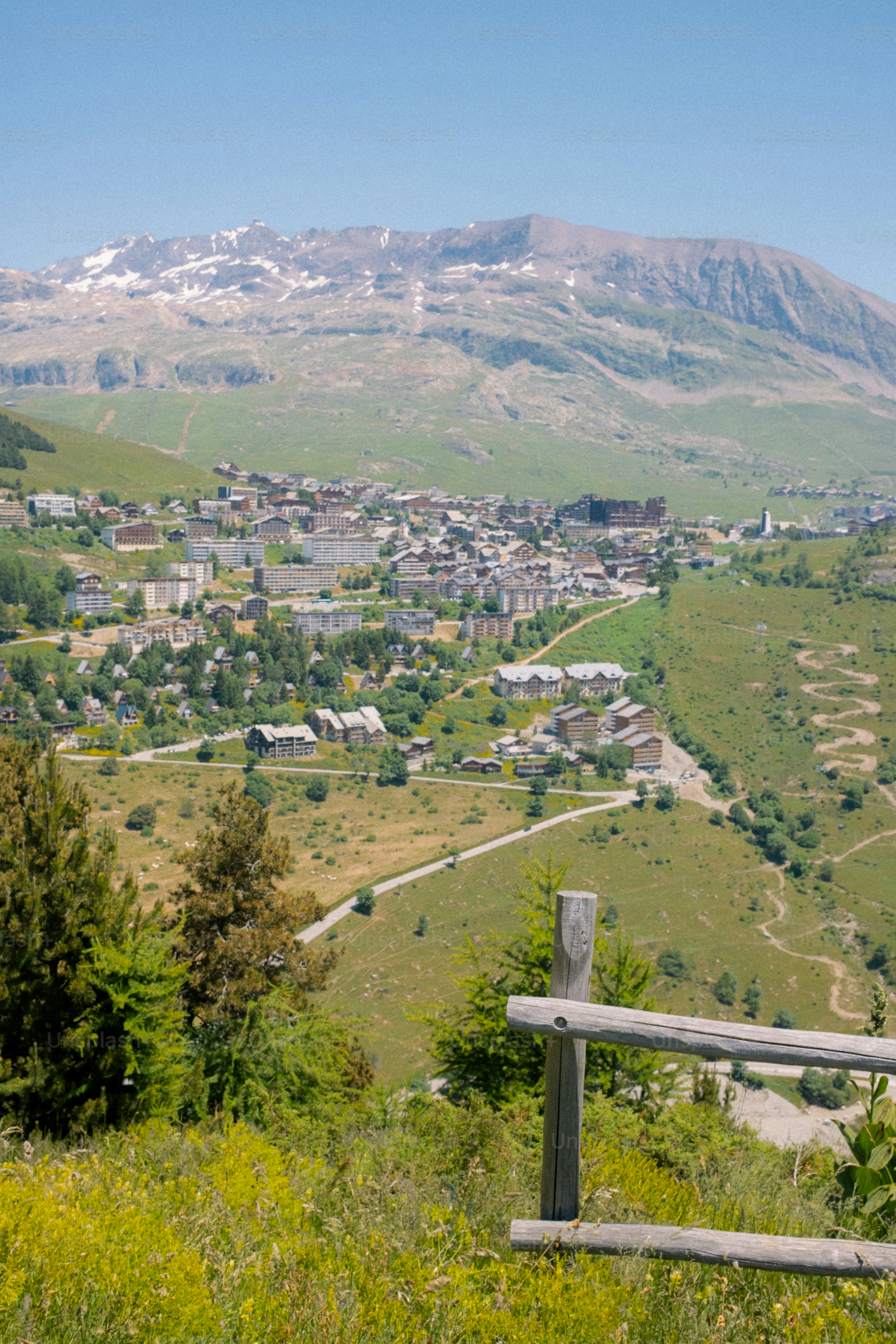 A village nestled in the valley with mountains.