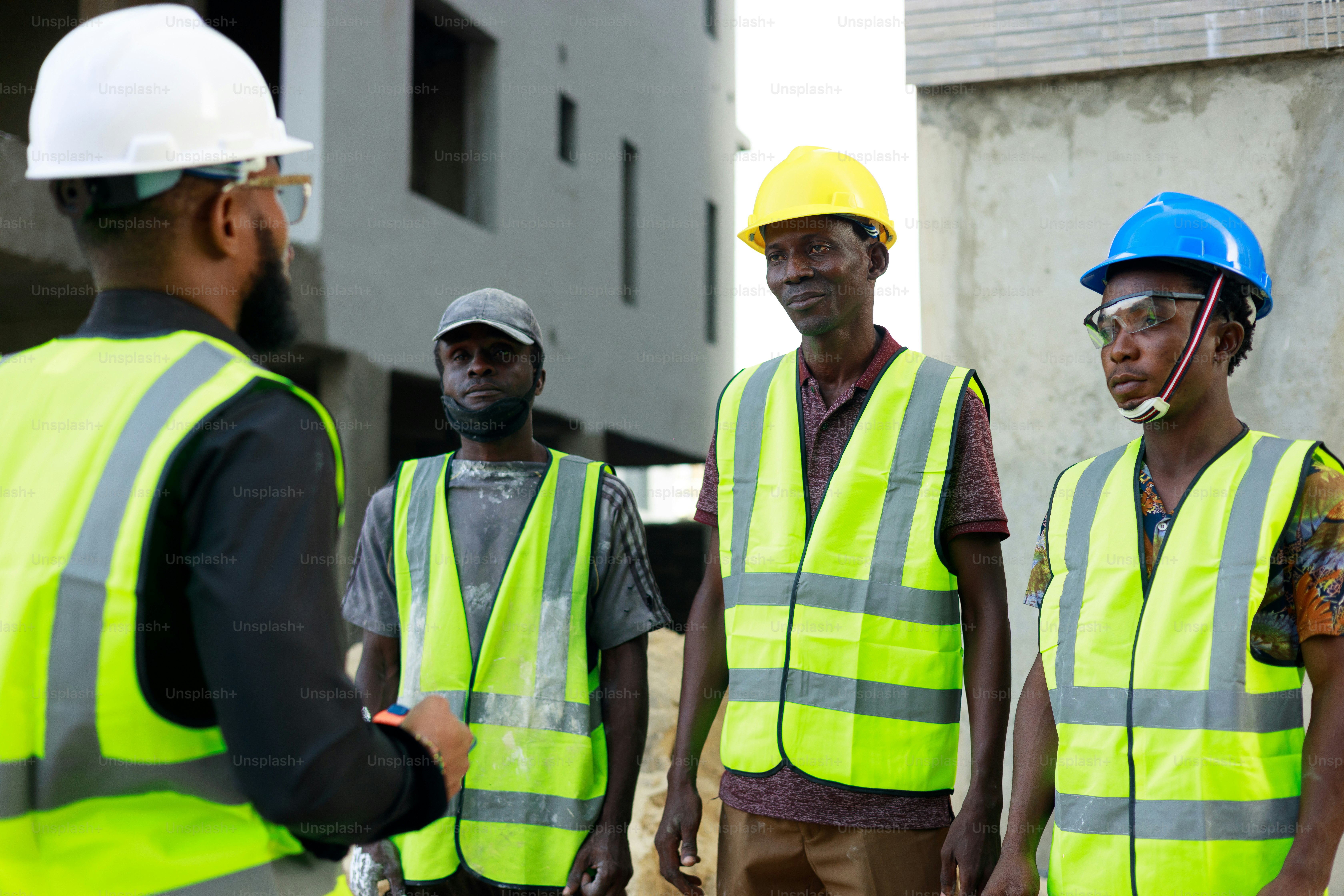 Construction workers in safety vests on job site