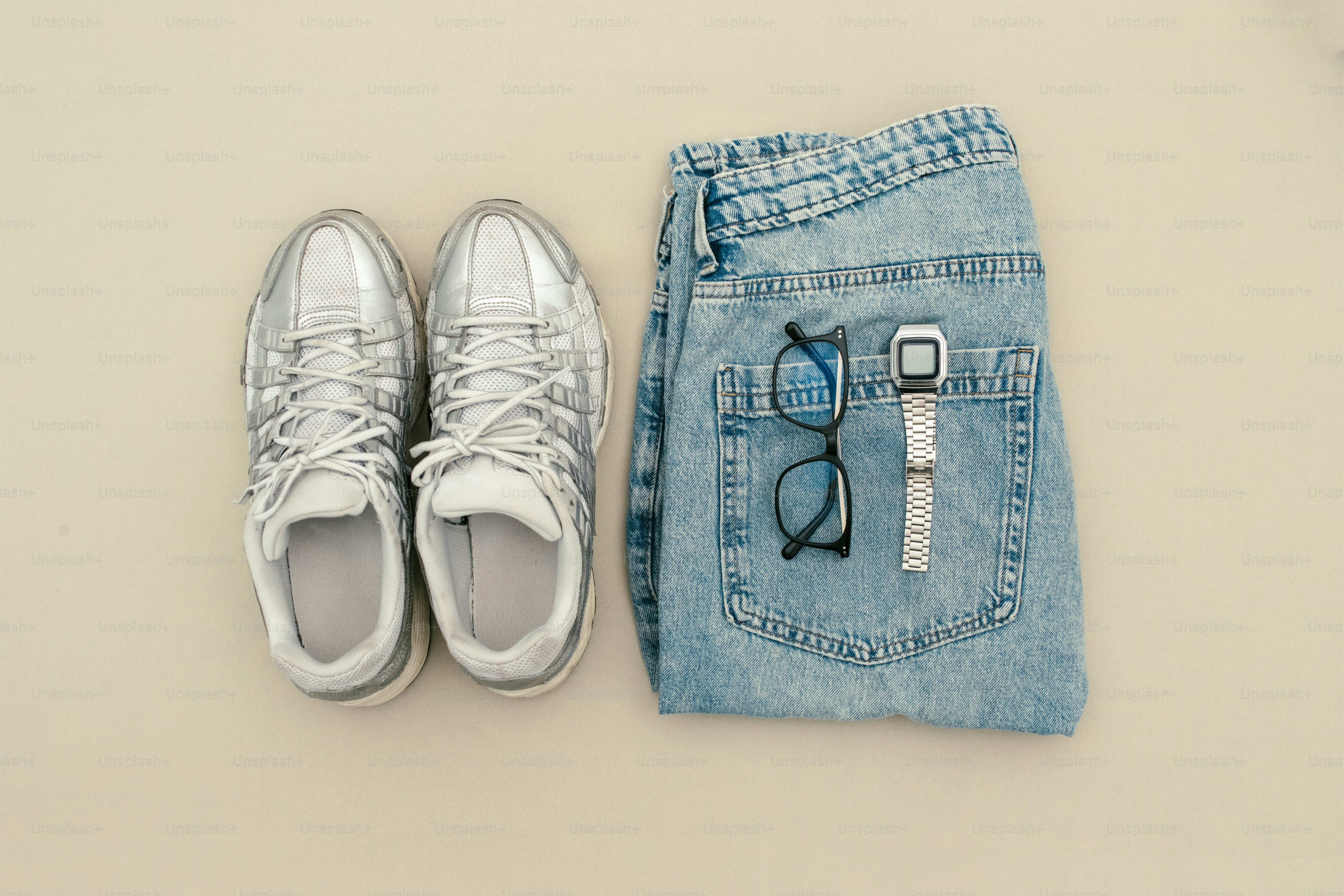 Silver shoes, jeans, glasses, and a watch.