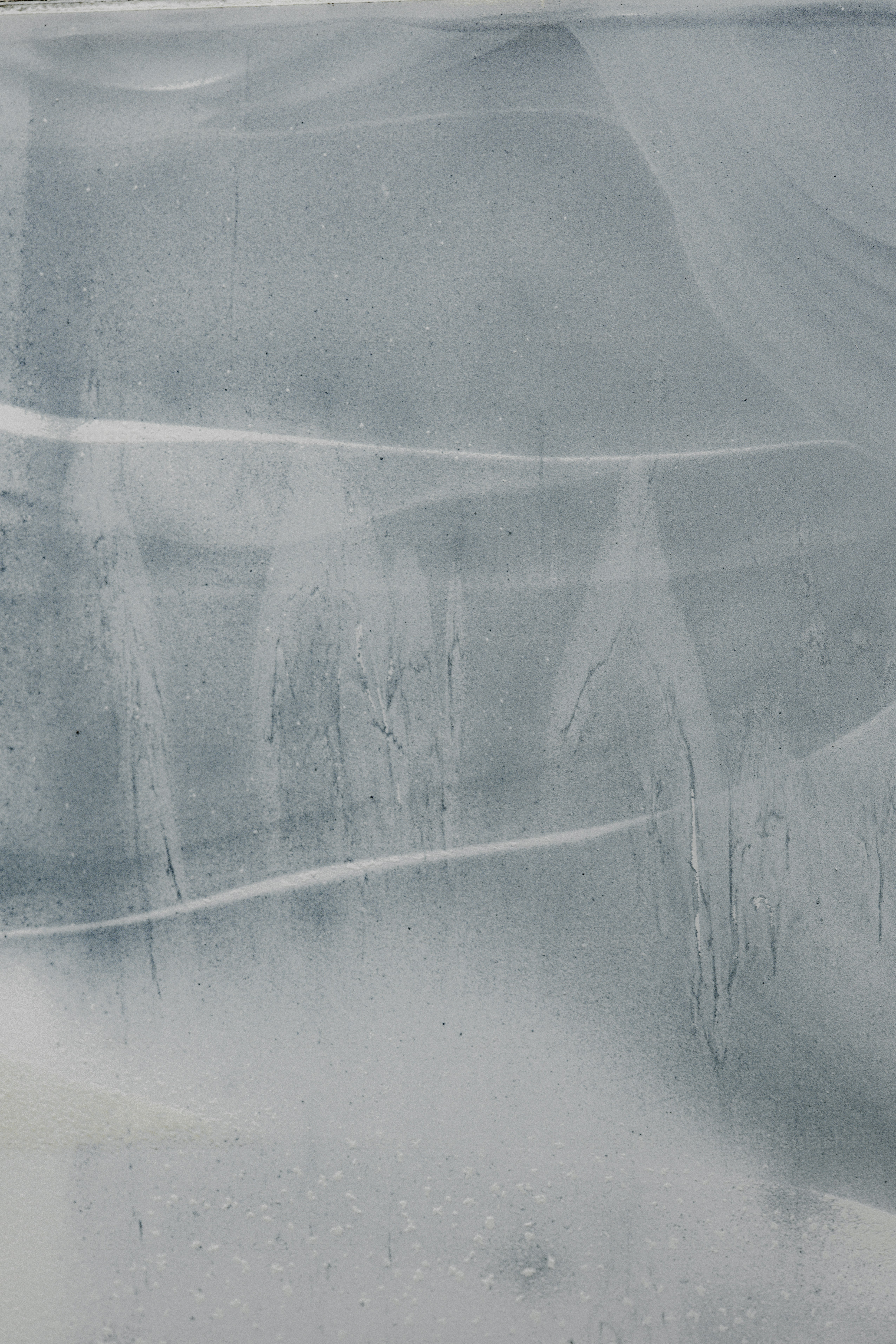 Abstract, pale background with light streaks.