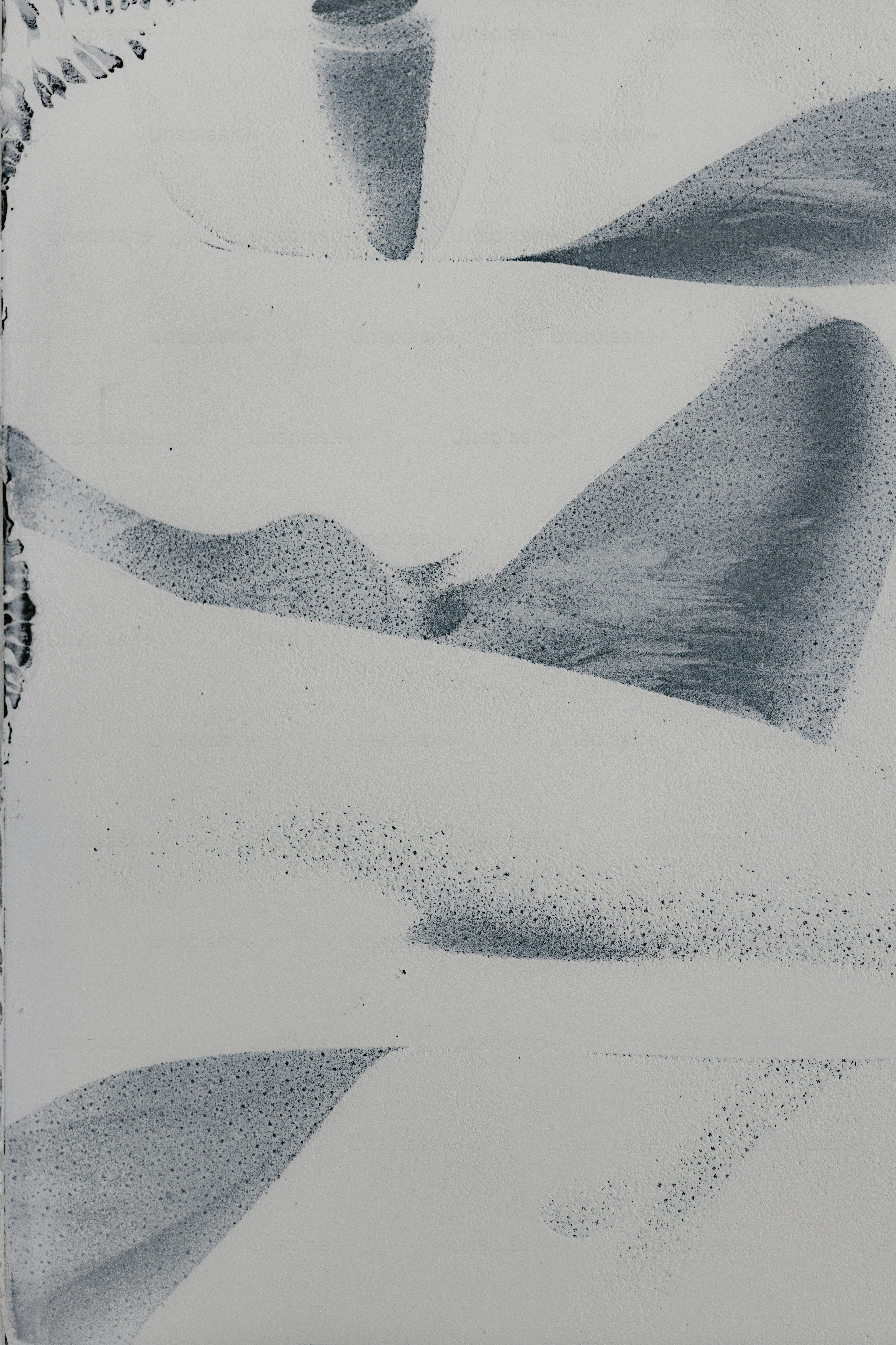 Abstract shapes in grey and white.