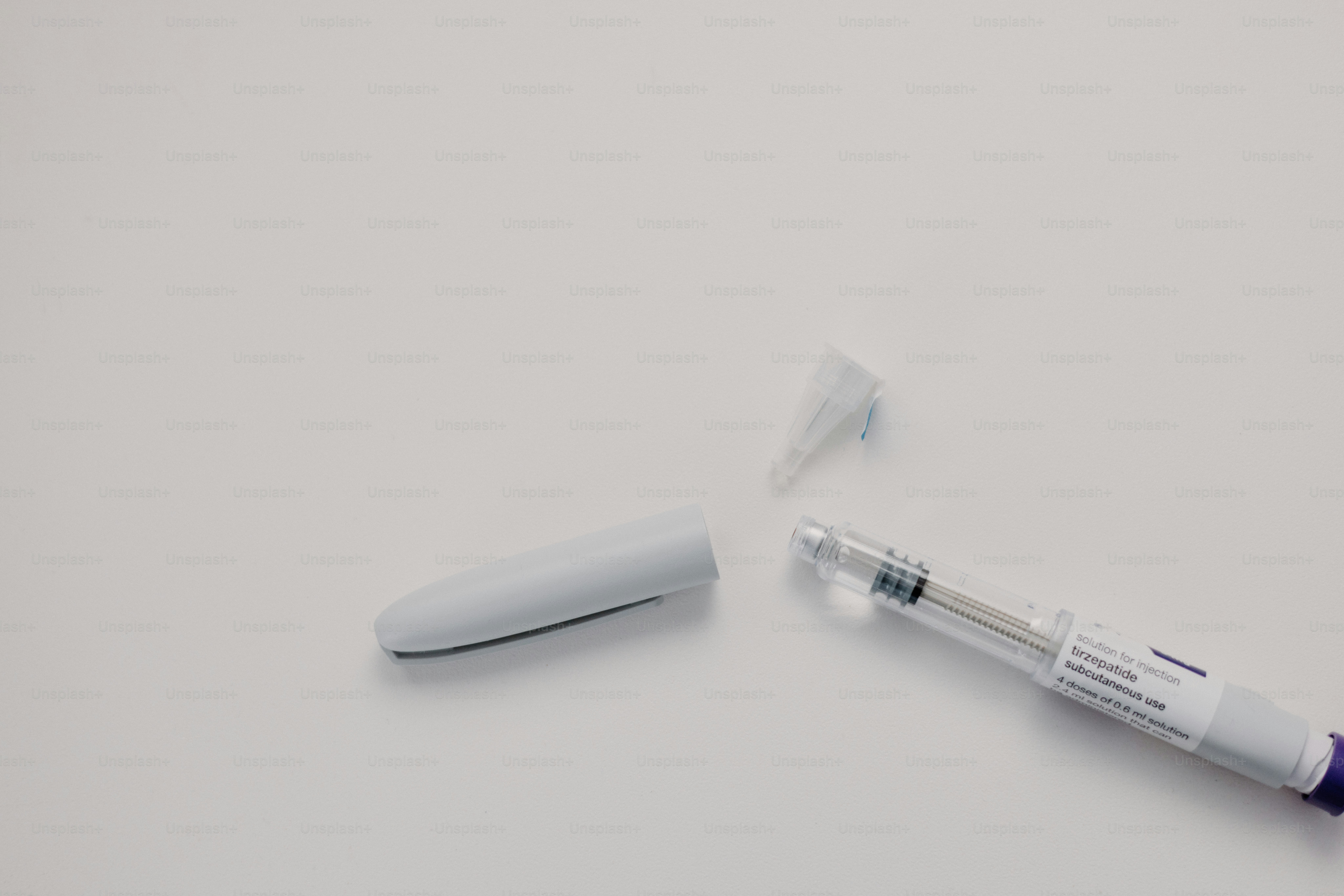 An insulin pen is open on a white surface.