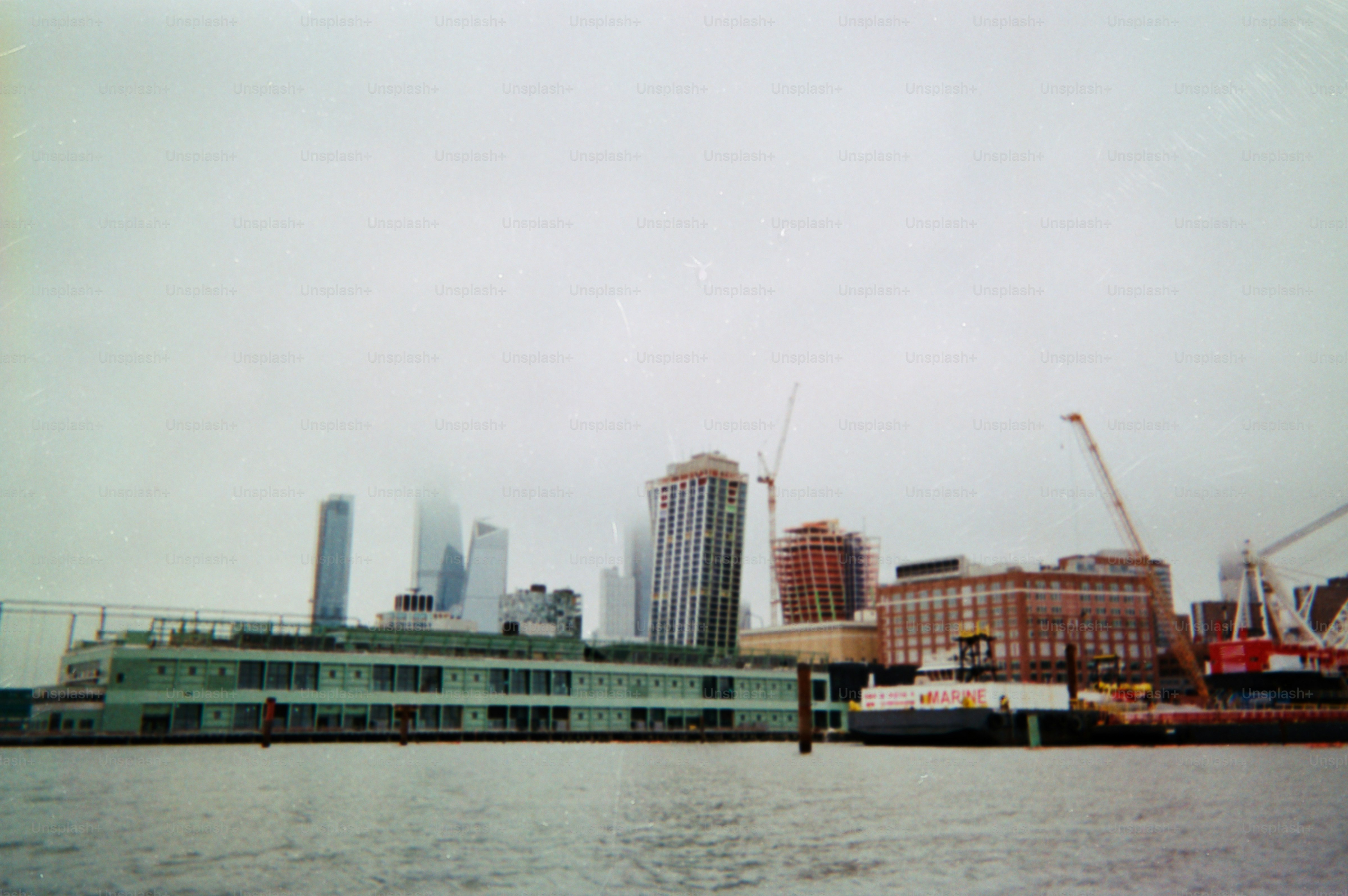 A cityscape with buildings under a cloudy sky.