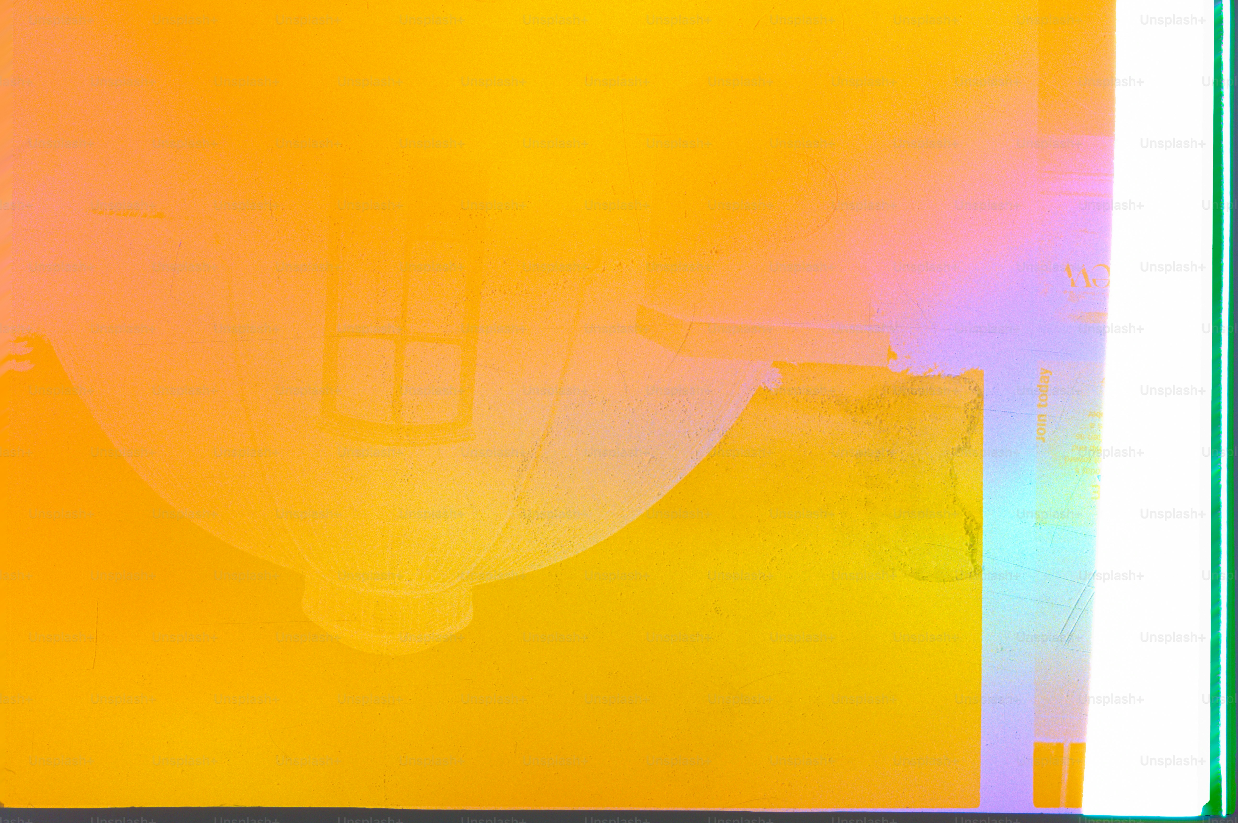 A teapot reflects on an iridescent, colorful surface.