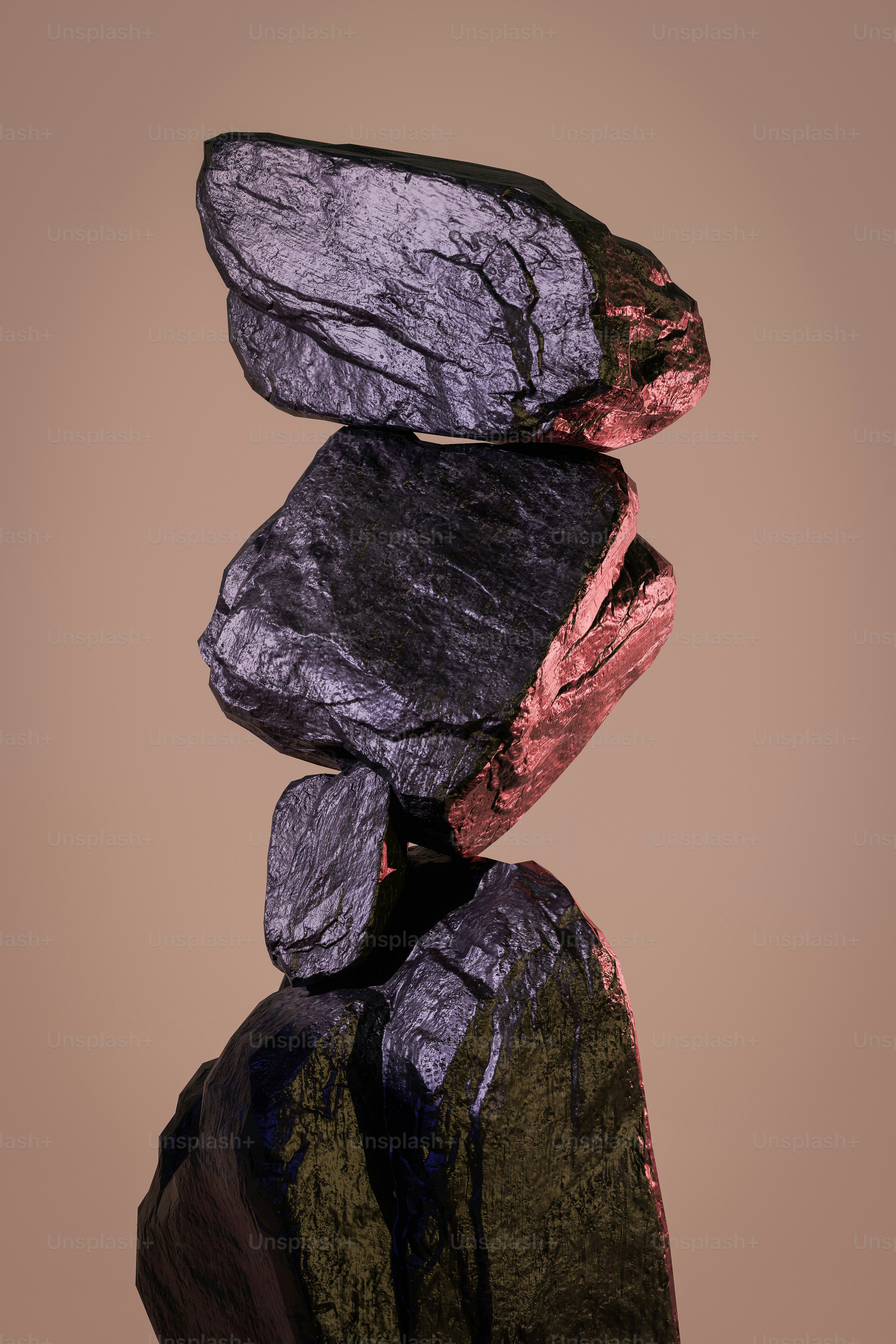 Balanced rocks stacked precariously against a neutral background.