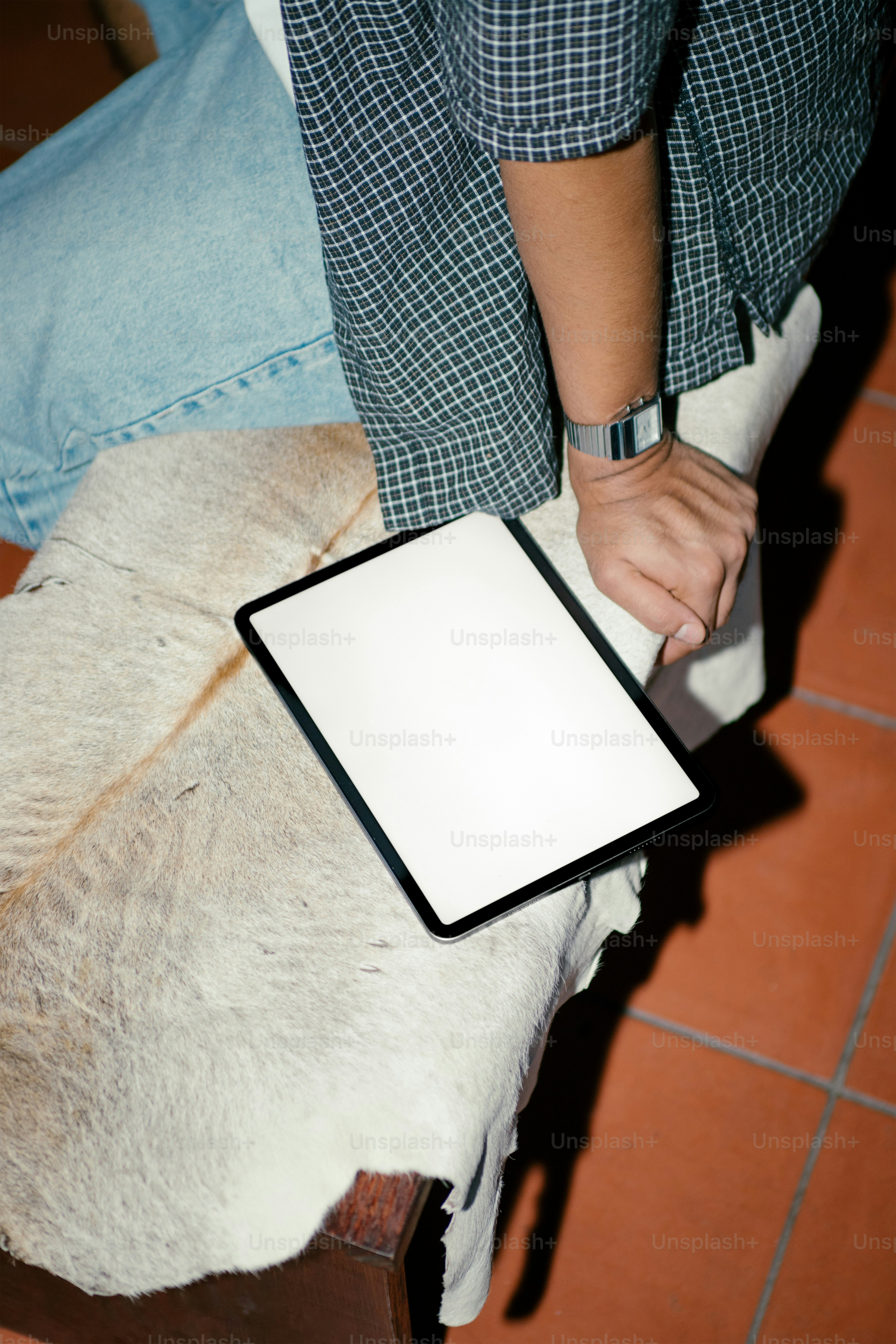 A person has a tablet on their lap.