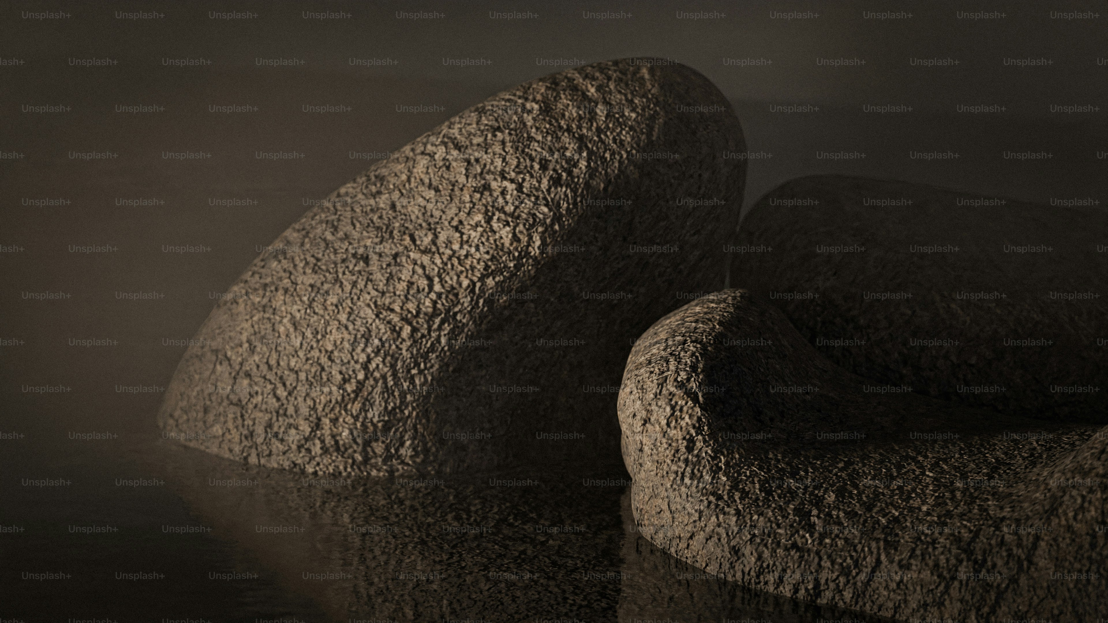 Rocks emerge from misty, dark waters