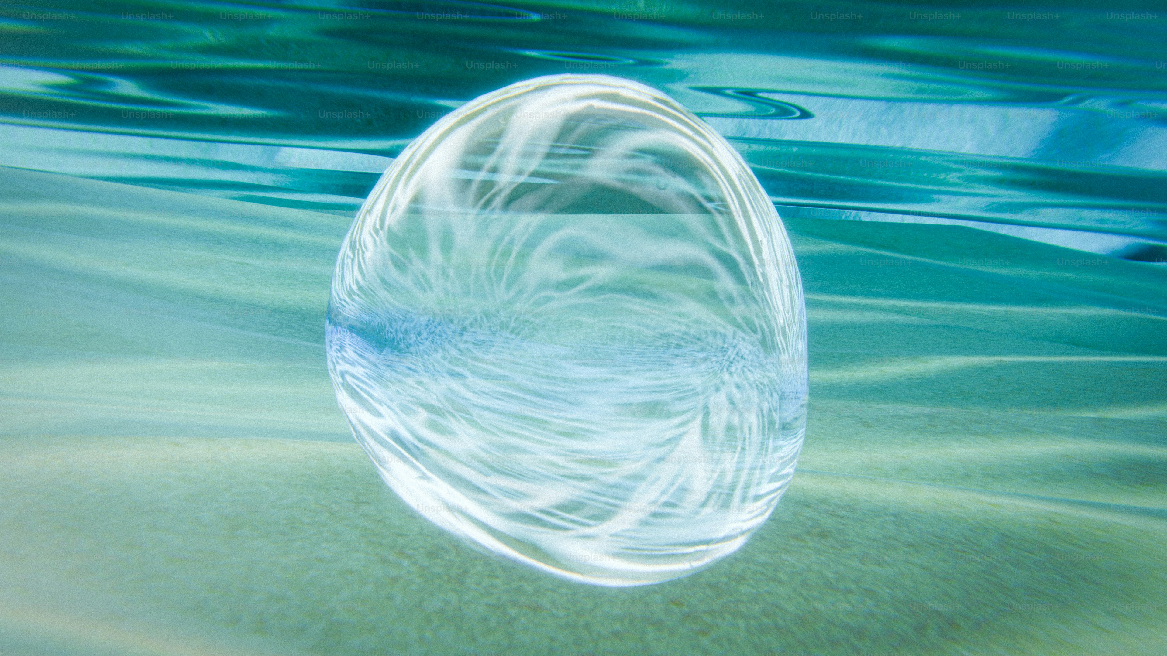 A glowing, swirling shape floats underwater. photo – Abstract Image on ...