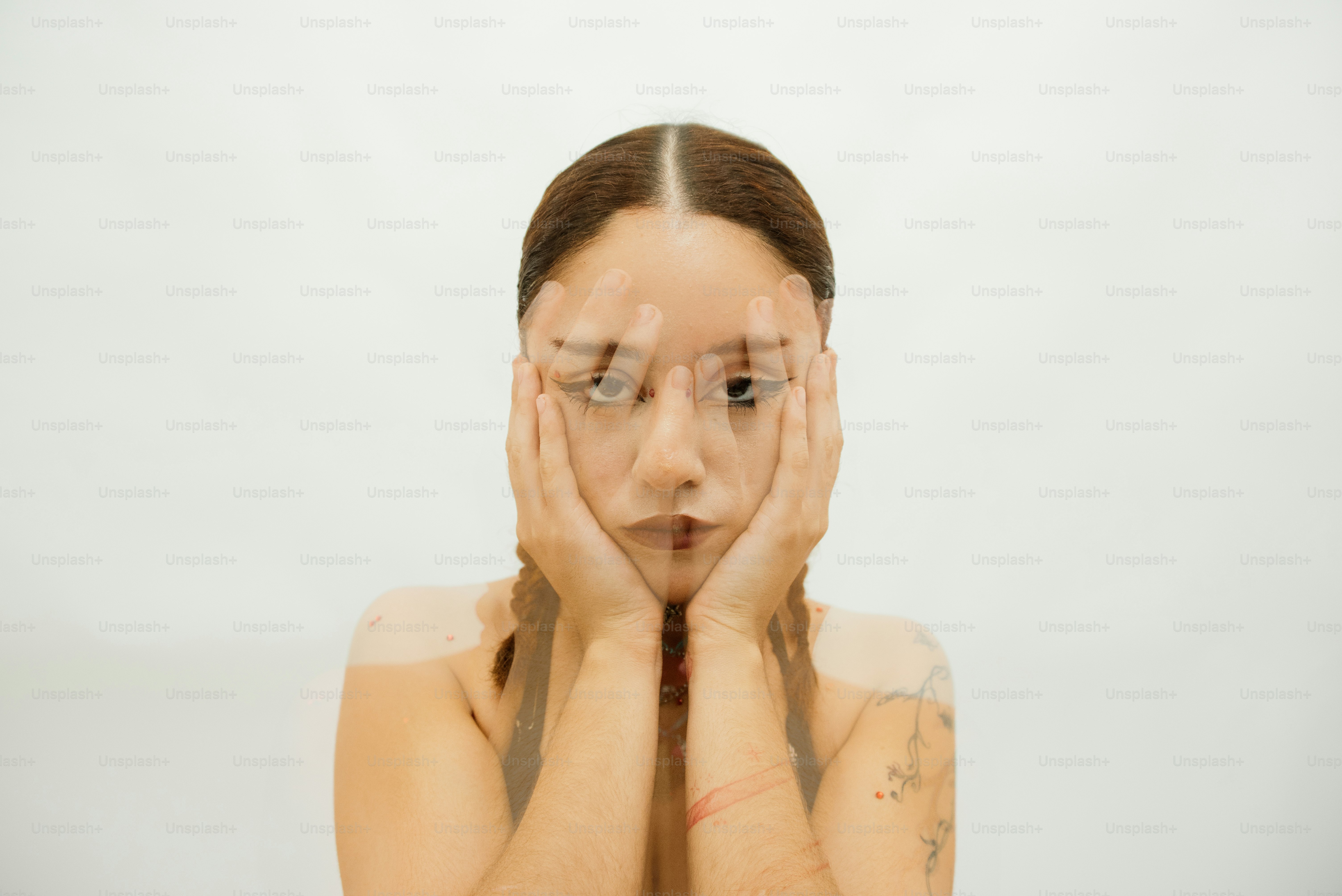 A woman's face is obscured by hands. photo – Identity Image on Unsplash