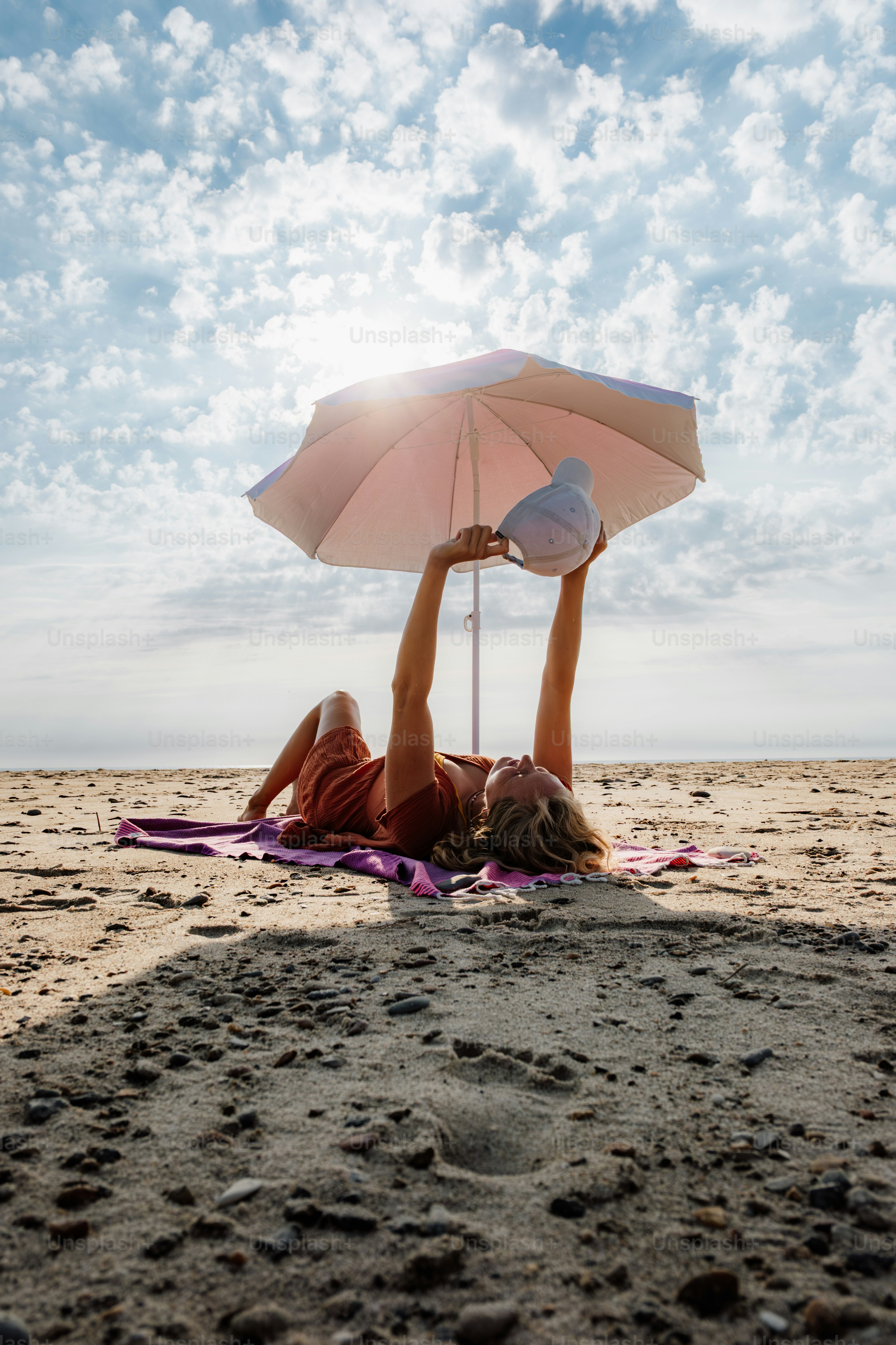 A woman walks into the ocean in a bikini. photo – Beach Image on Unsplash