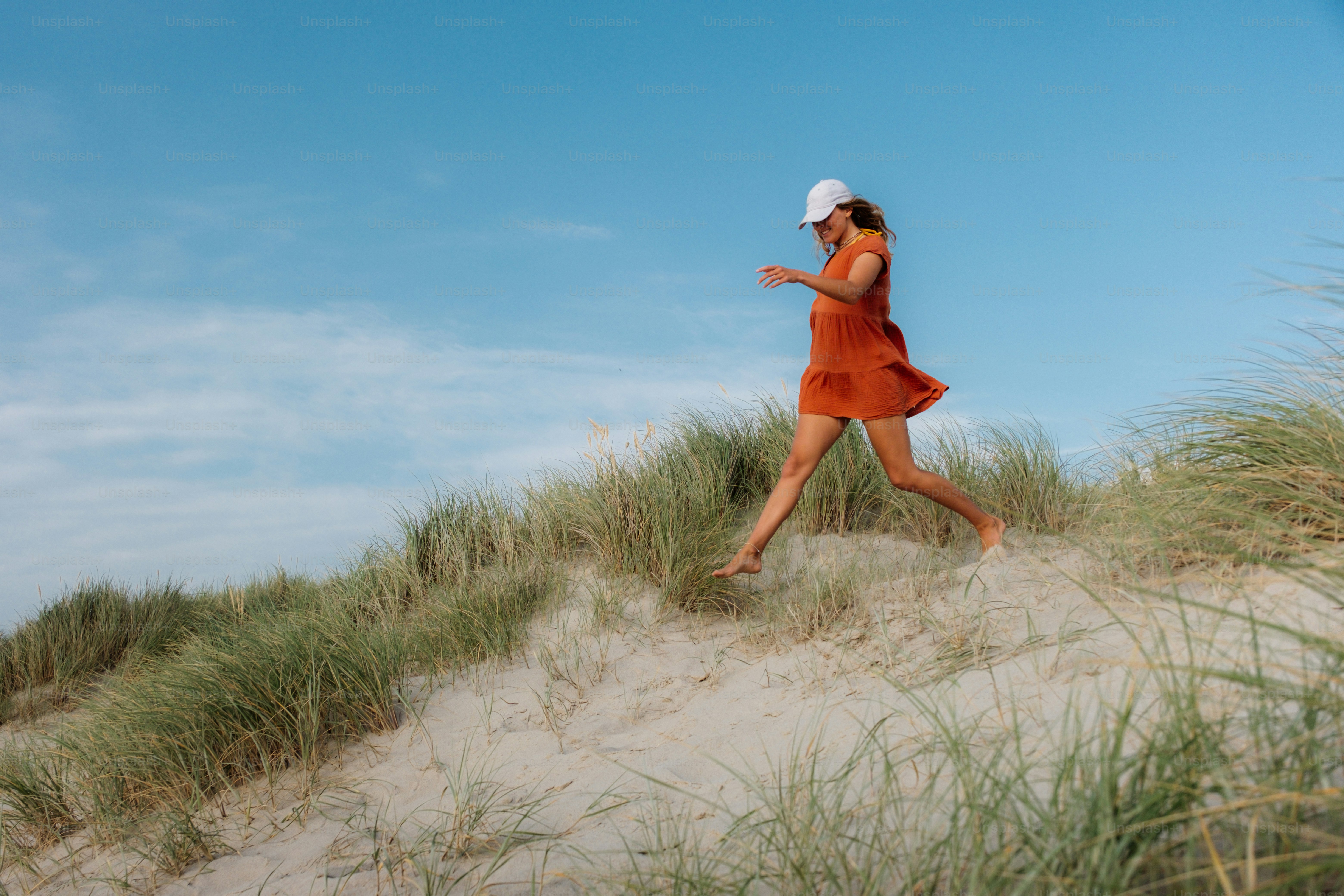 A woman walks into the ocean in a bikini. photo – Beach Image on Unsplash