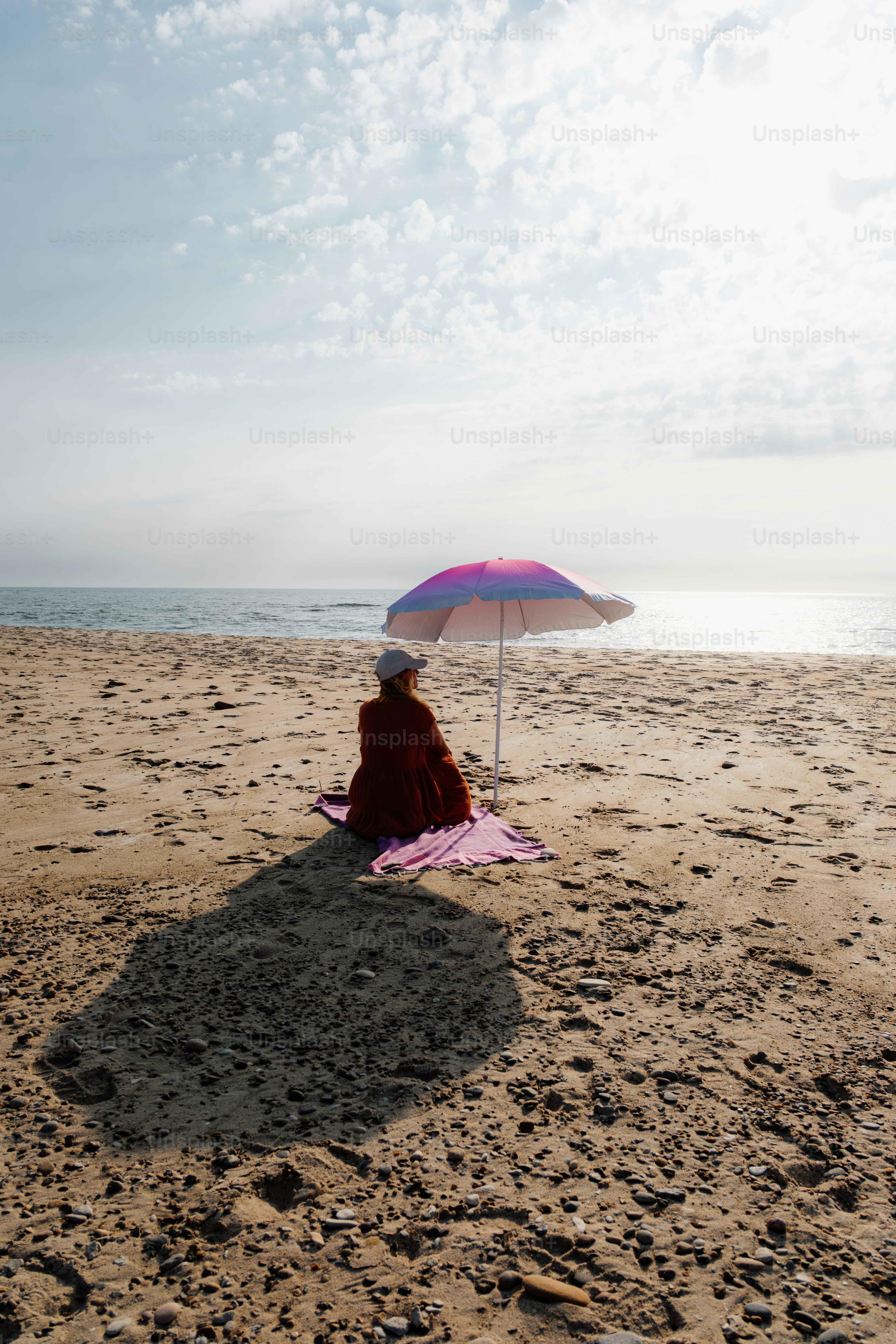 A woman walks into the ocean in a bikini. photo – Beach Image on Unsplash