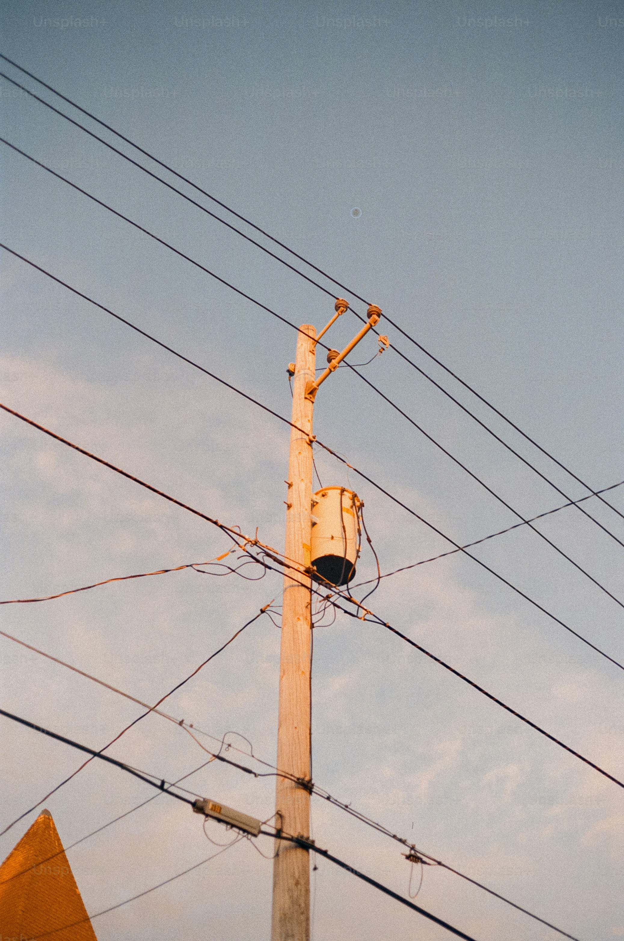 Power lines and a pole against a blue sky