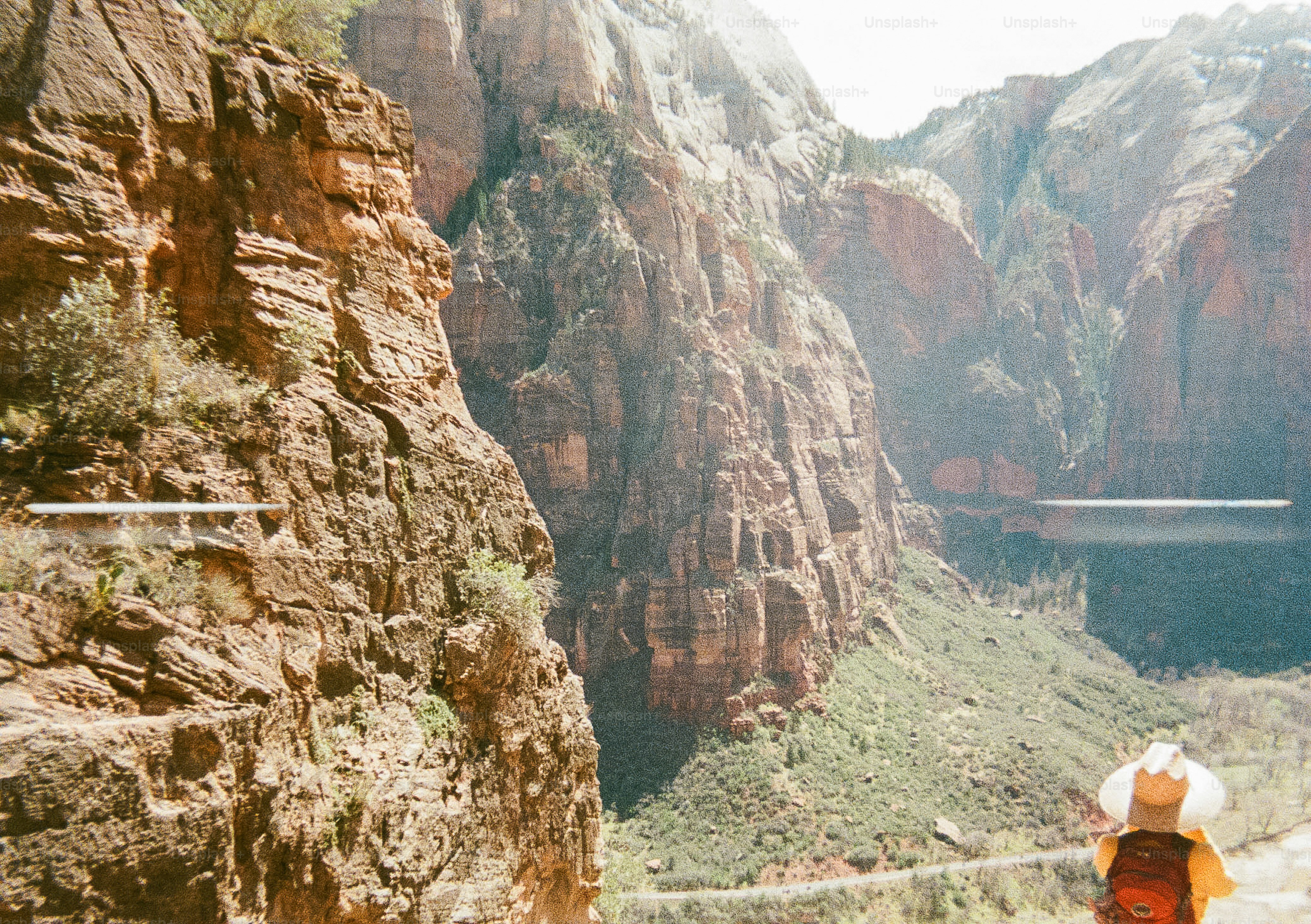 Hiker observes a mountainous canyon landscape.