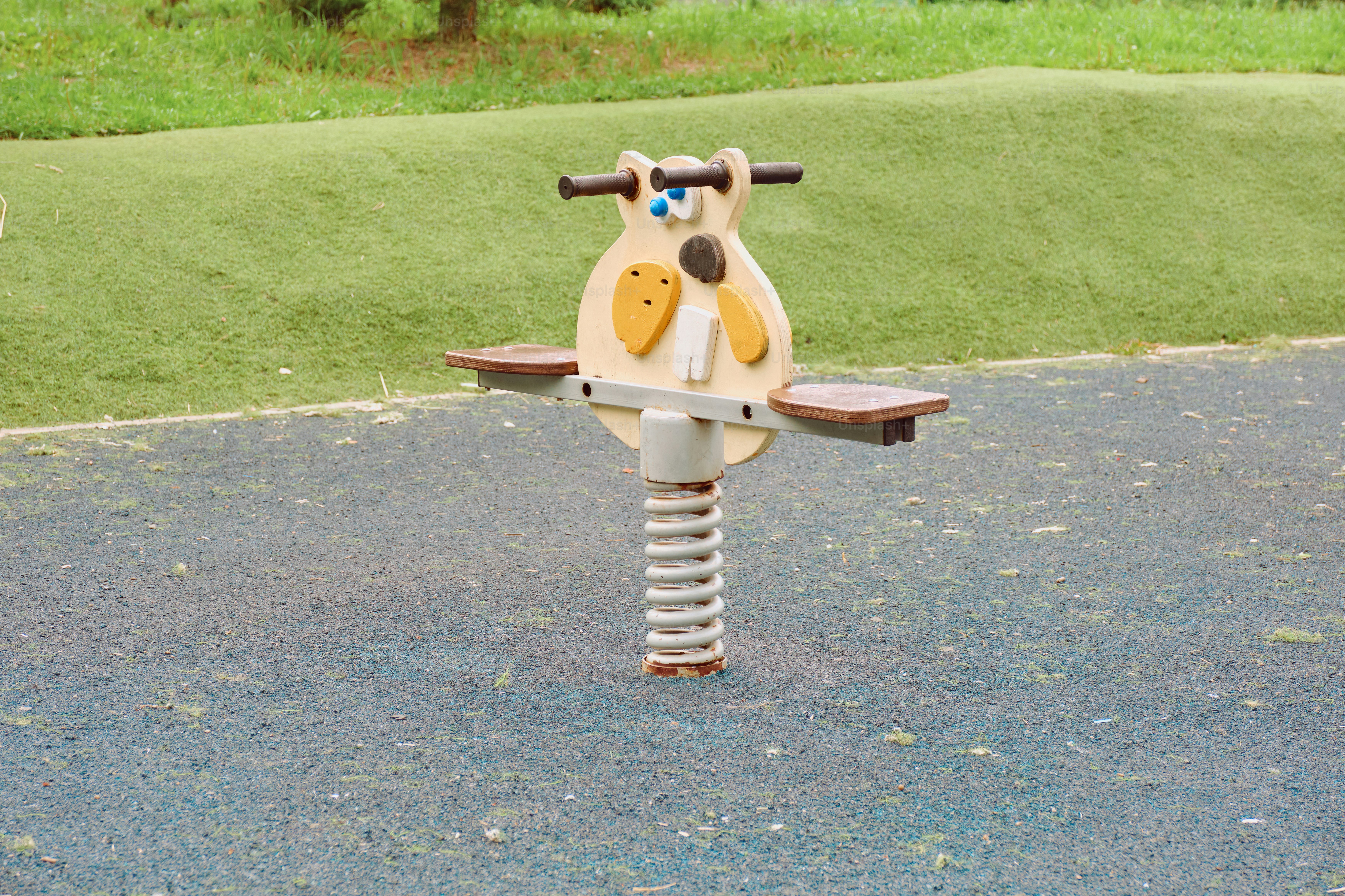 A spring ride is located on a playground.