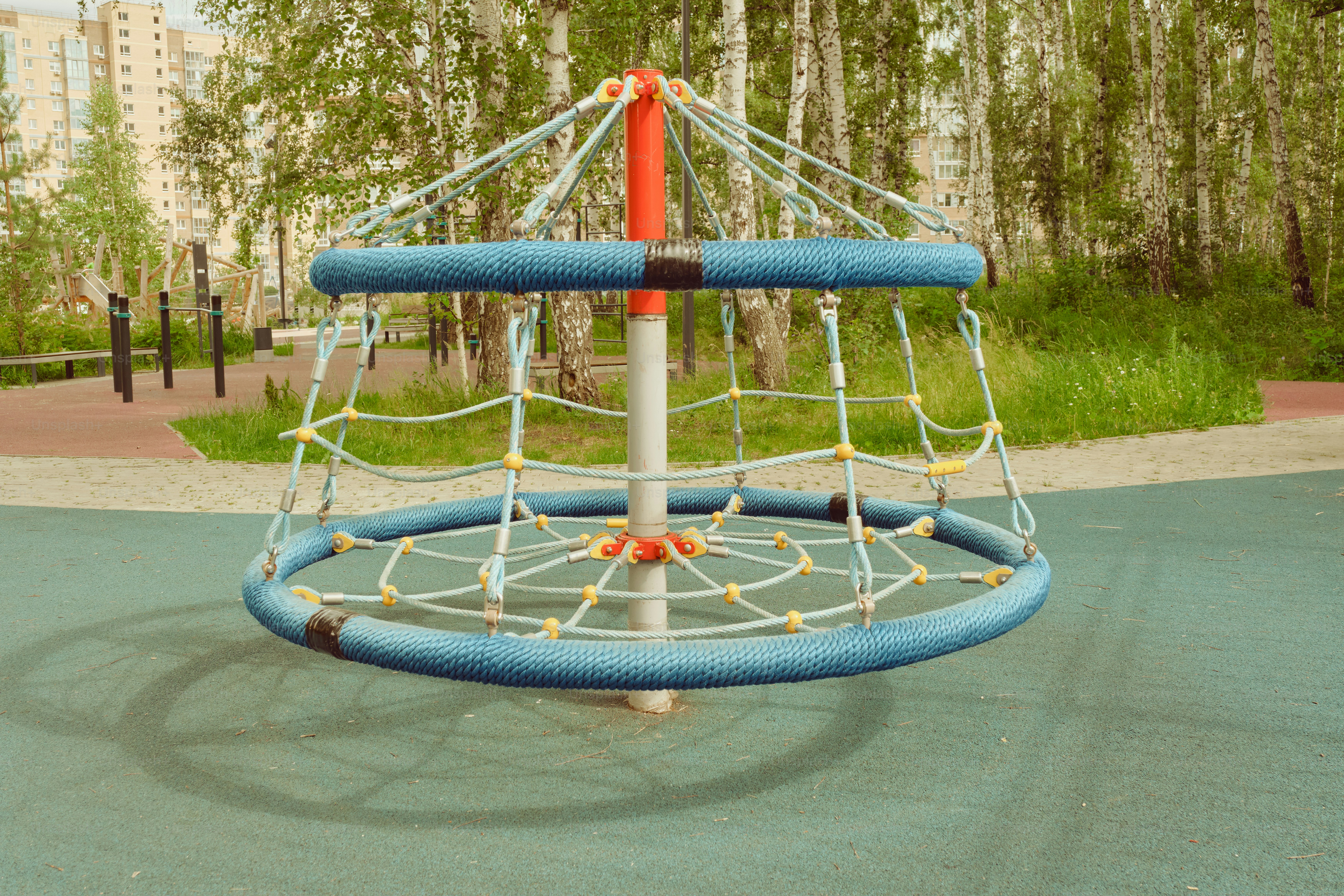A rope climbing structure sits at the playground.