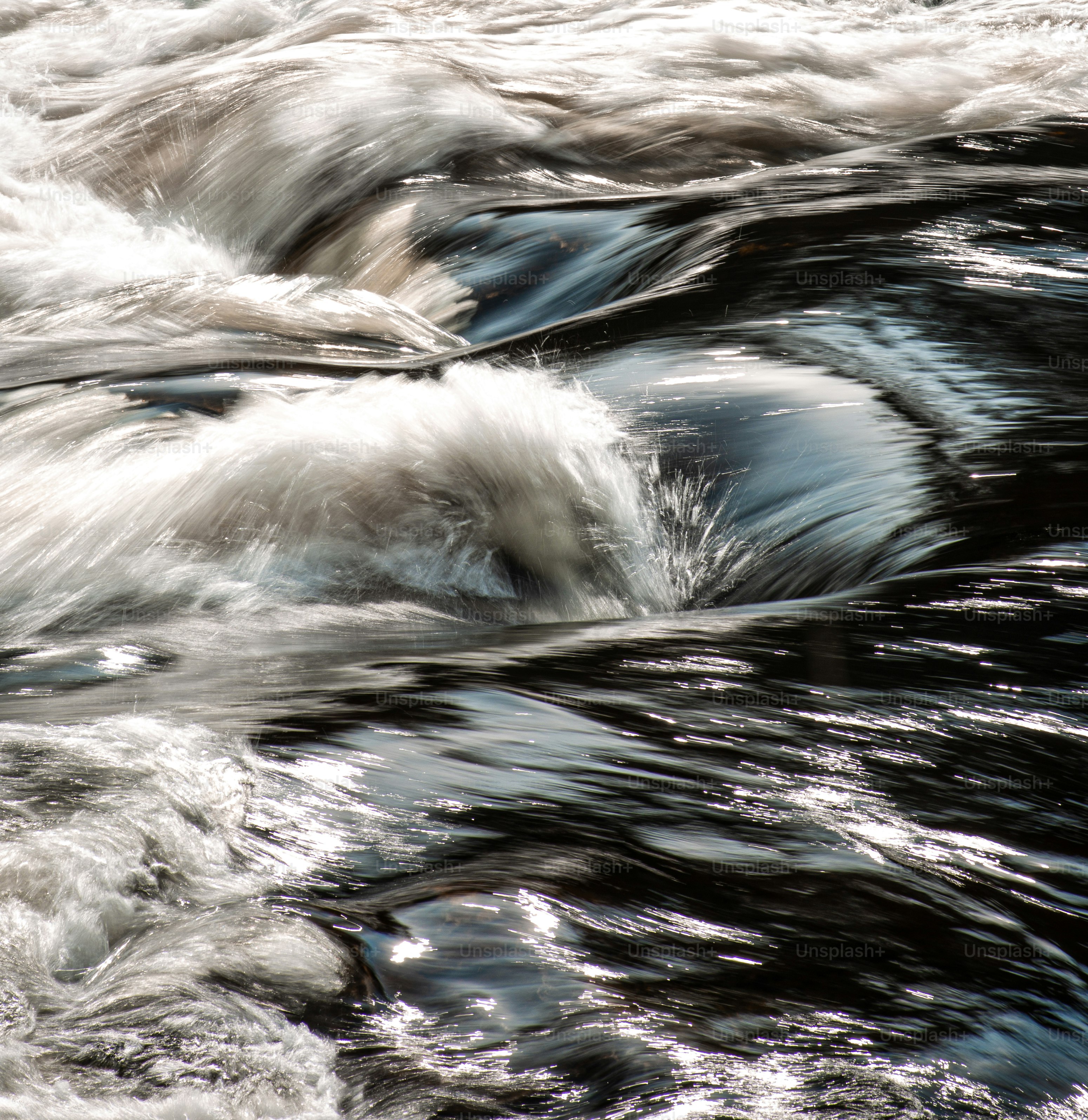 Turbulent water rushes with foamy white crests
