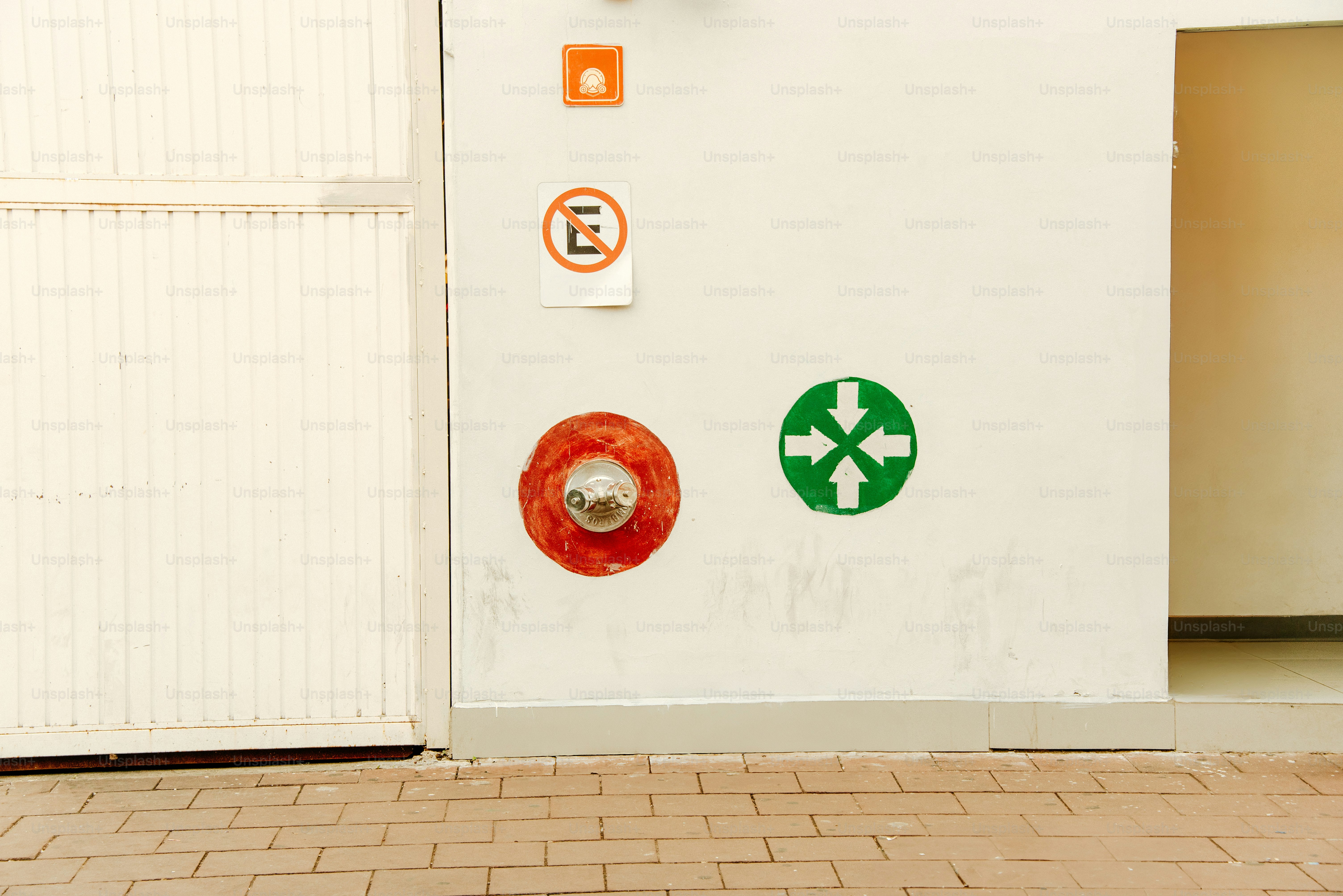 Fire safety and direction signage on a wall.