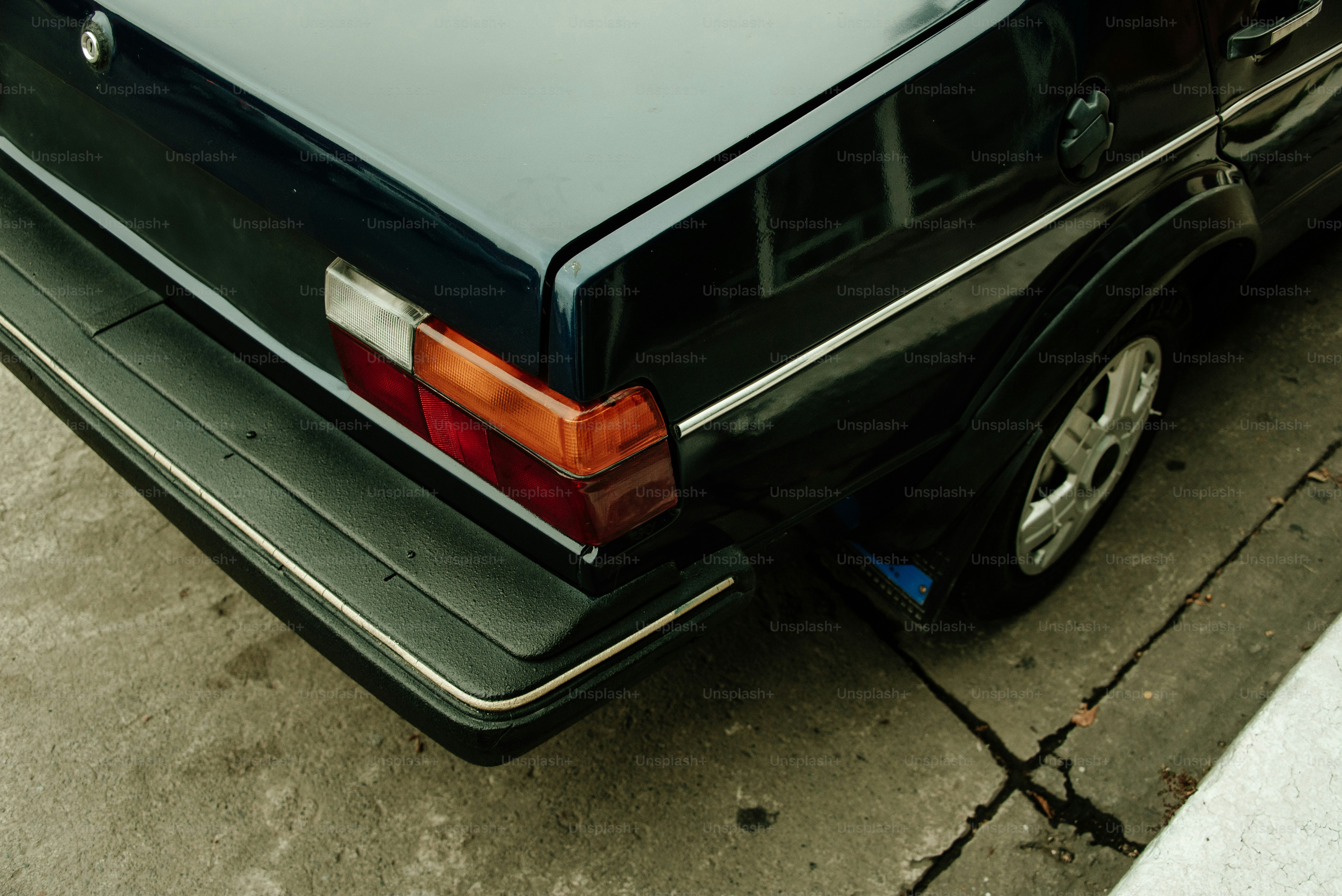 The rear end of a dark blue car.
