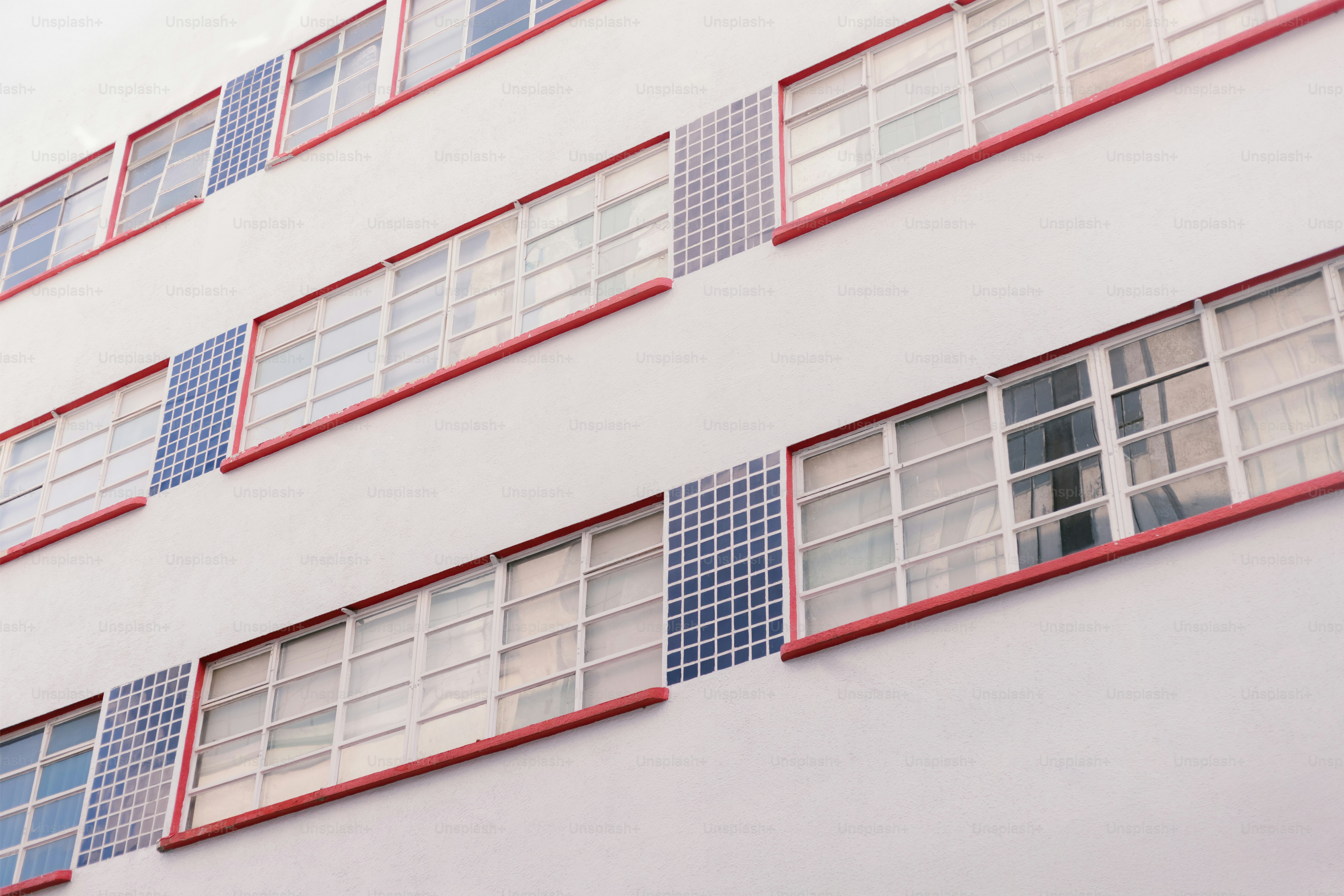 Building facade with windows and checkered details.