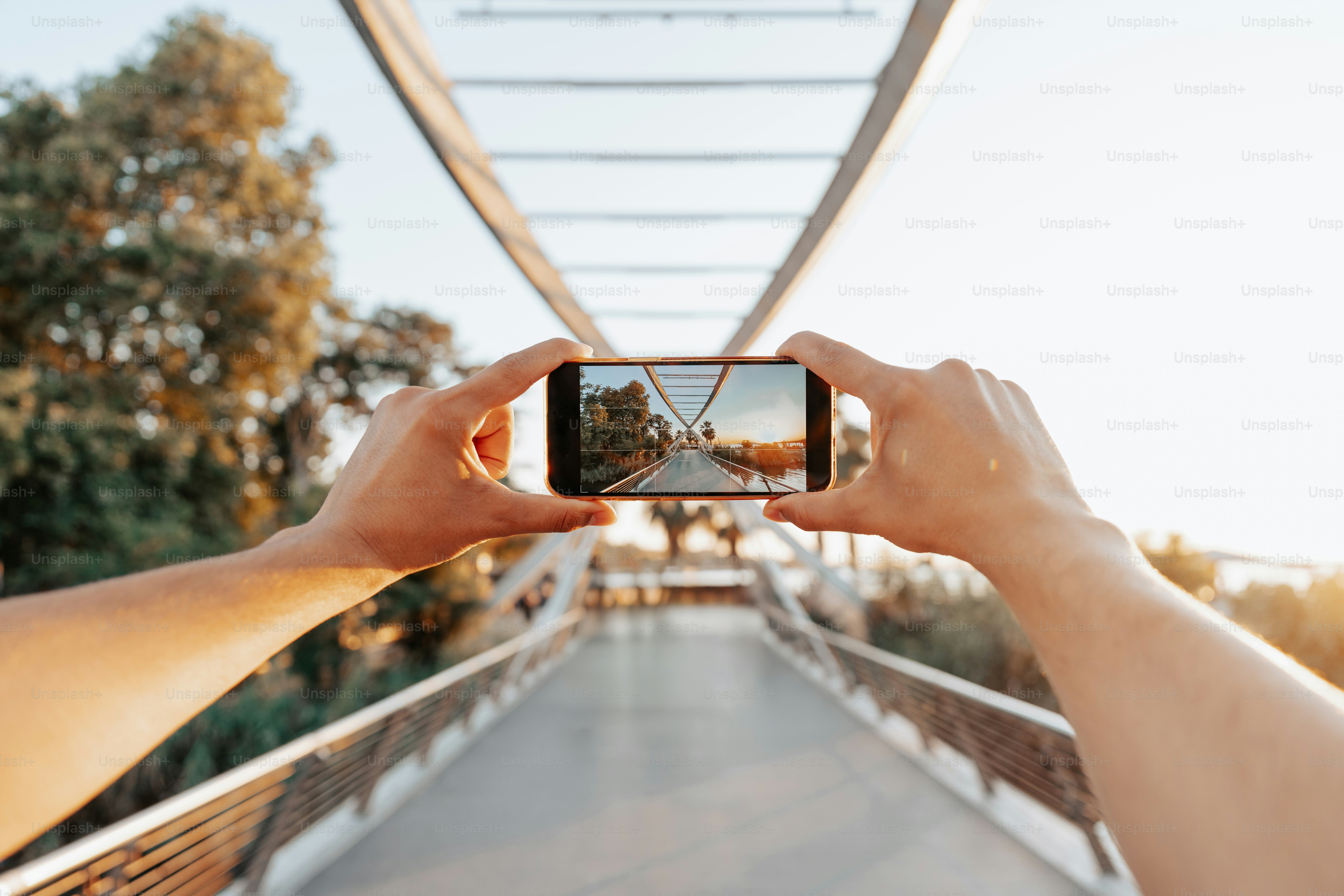 Taking a picture of a bridge on a phone.