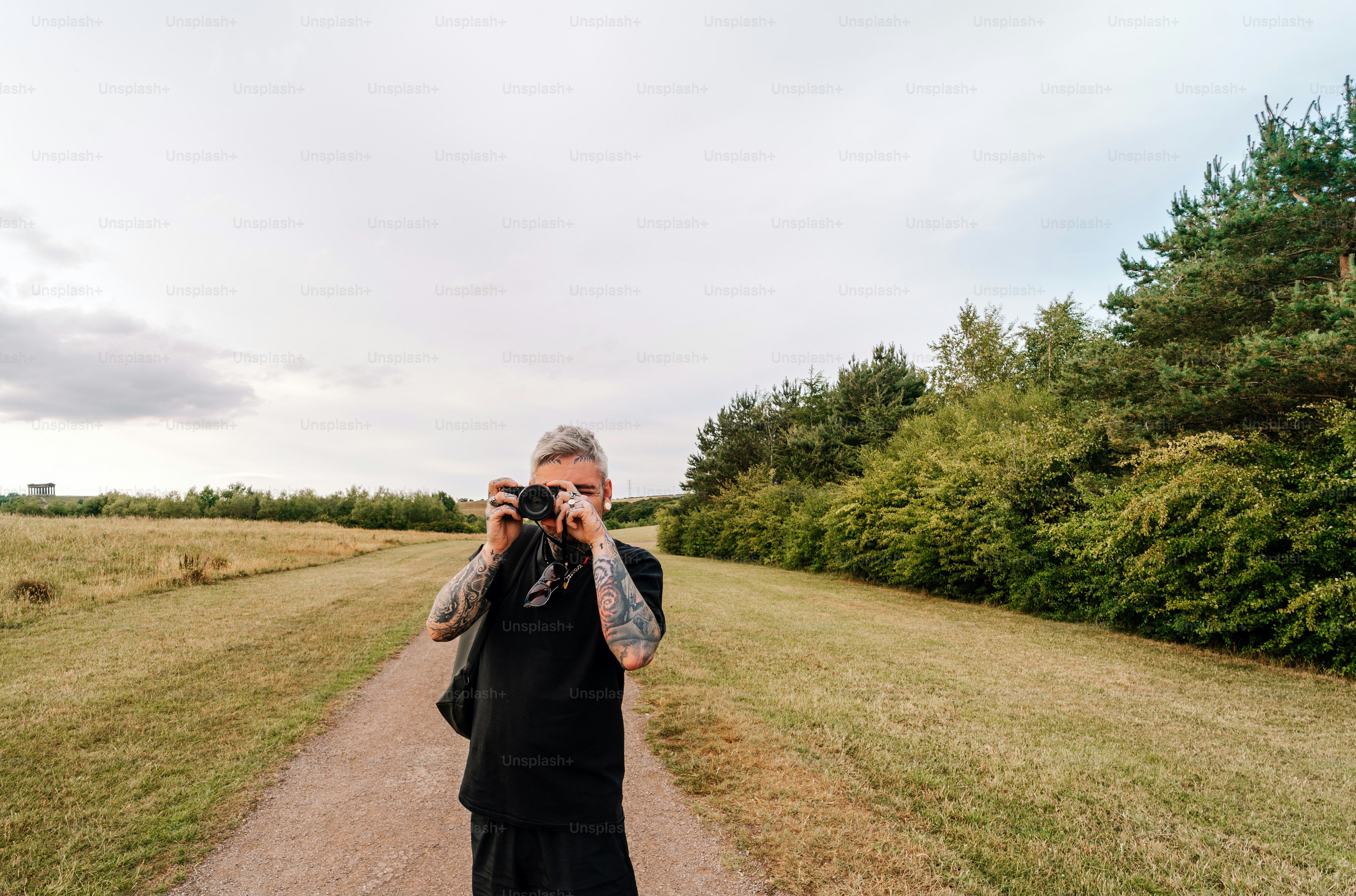 A man takes a photo with a camera.