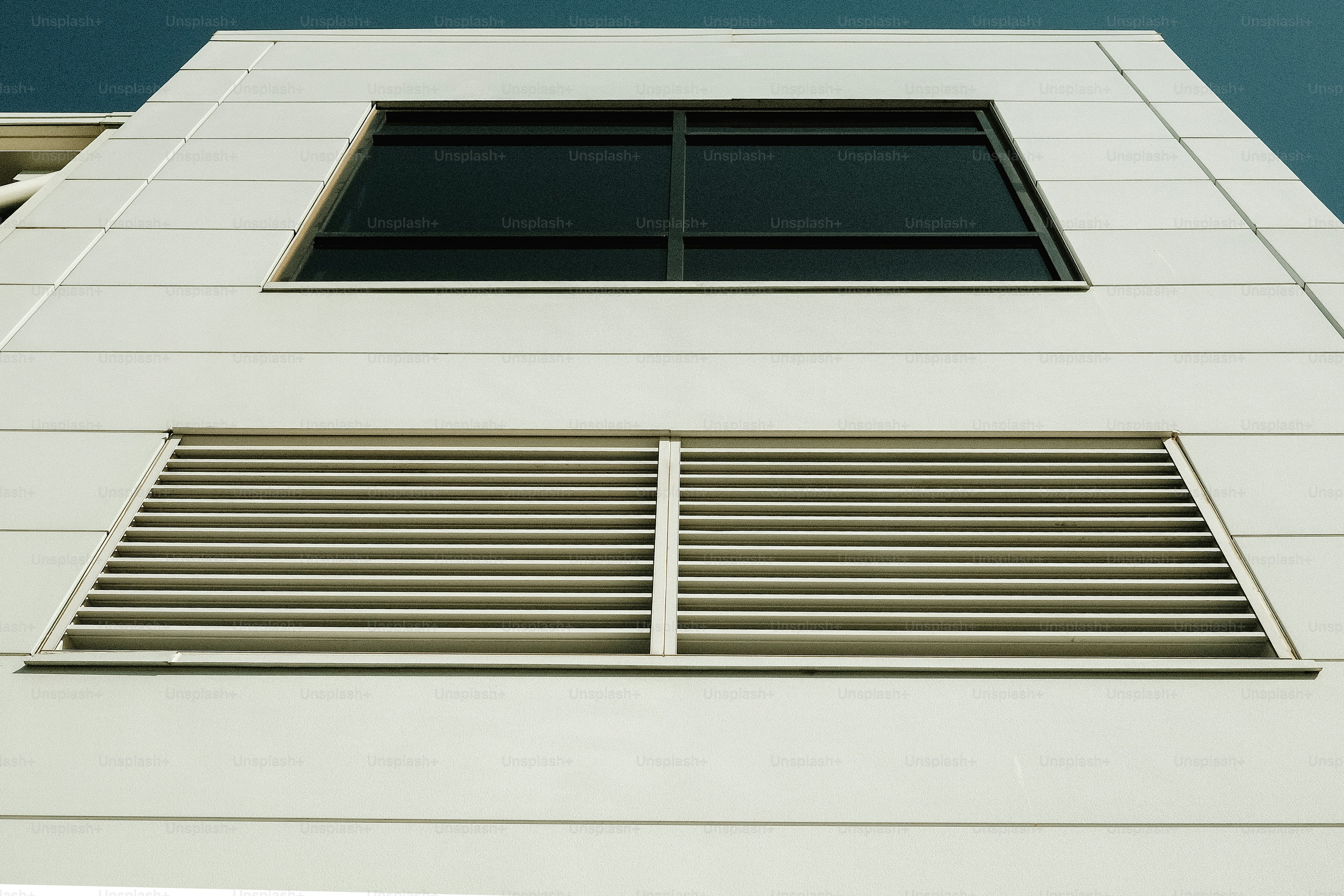 Building facade with window and vents.