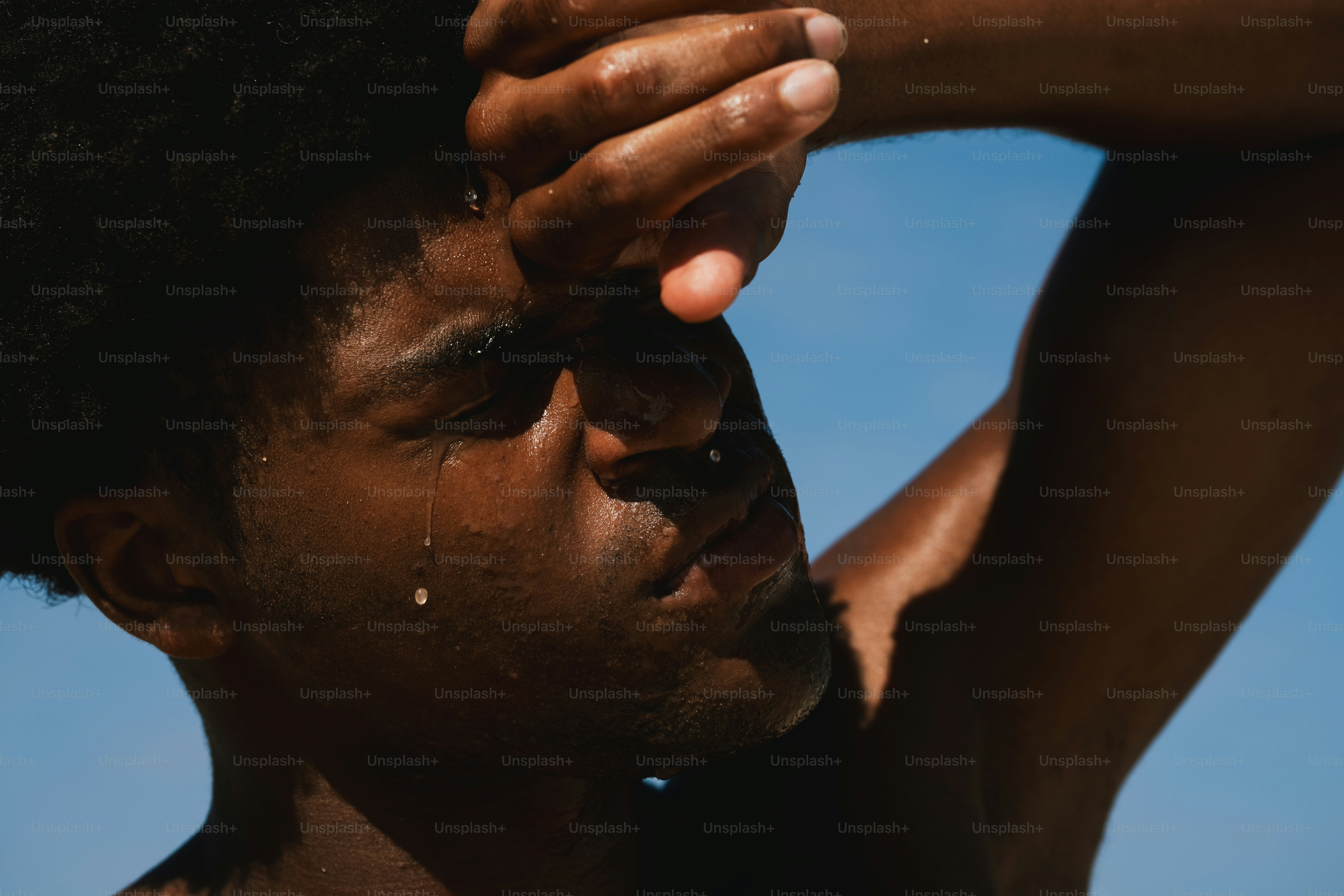 A sweaty man wipes sweat from his forehead. photo – Summer Image on ...